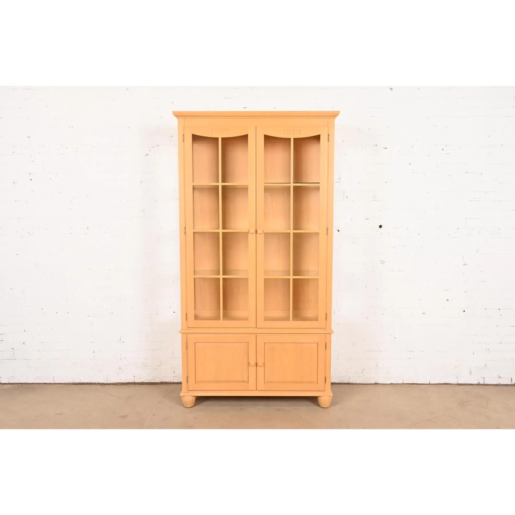 A gorgeous Arts & Crafts or Shaker style lighted bookcase or display cabinet

USA, Late 20th Century

Carved maple, with mullioned glass front doors and sides. Interior shelves are adjustable.

Measures: 41.25