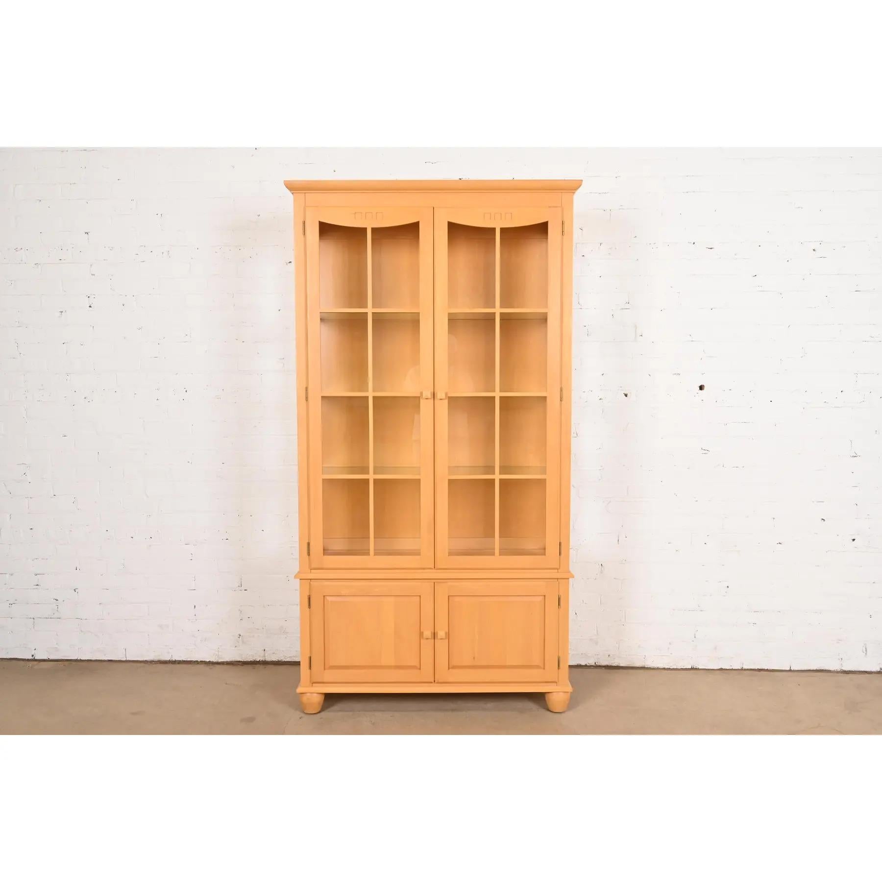 A gorgeous Arts & Crafts or Shaker style lighted bookcase or display cabinet

USA, Late 20th Century

Carved maple, with mullioned glass front doors and sides. Interior shelves are adjustable.

Measures: 41.25