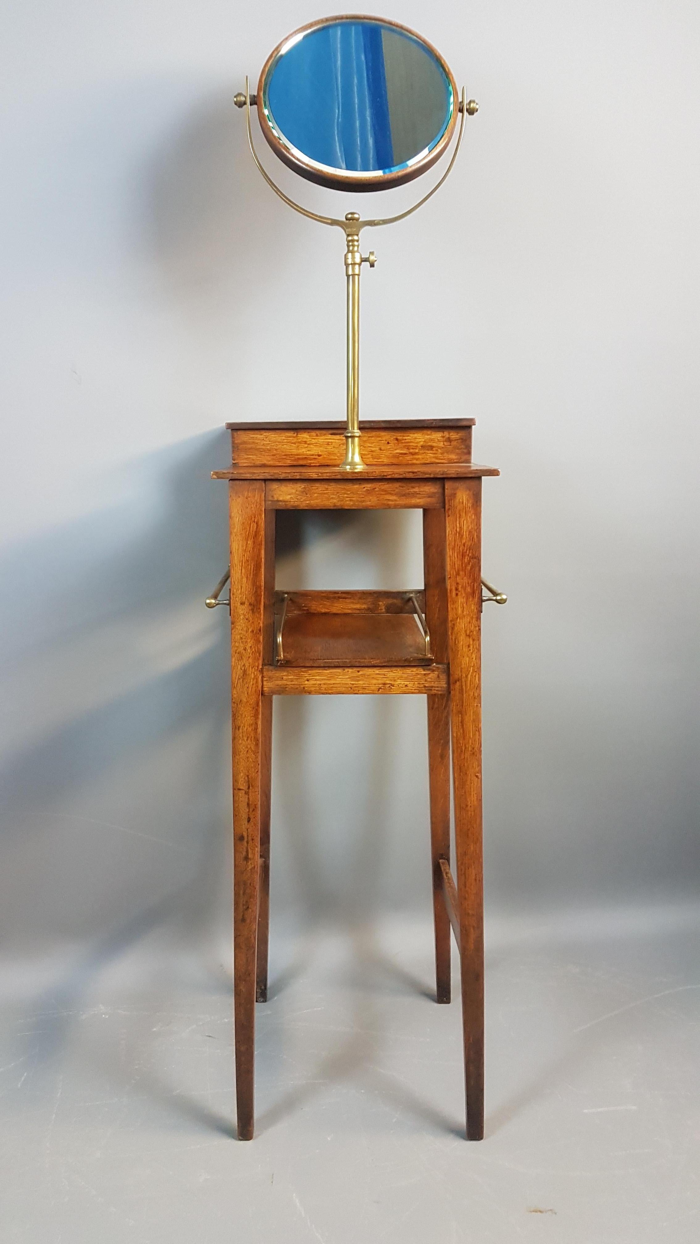 A superb oak Arts & Crafts shaving stand in the manner of liberty’s. It is of the same quality and similar in design to those sold by the London retailer during the late 19th and early 20th century. The oak framed mirror is adjustable on the brass