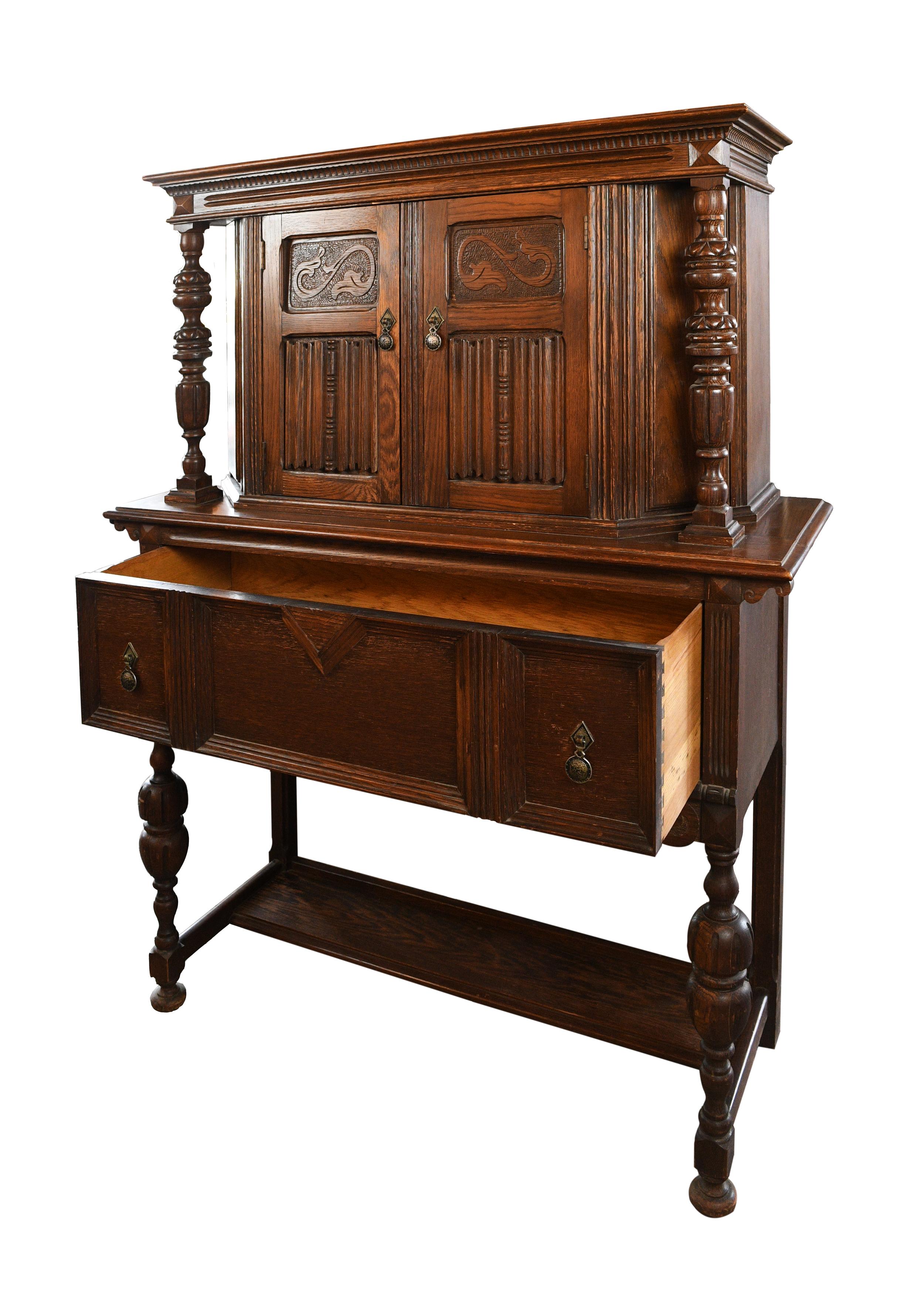 This gorgeous Arts & Crafts sideboard features decorative posts on either side, organic ornamentation throughout, and ample storage. At only 16” deep and 44” wide, it won’t take up much space, making it a great choice for smaller rooms,

circa