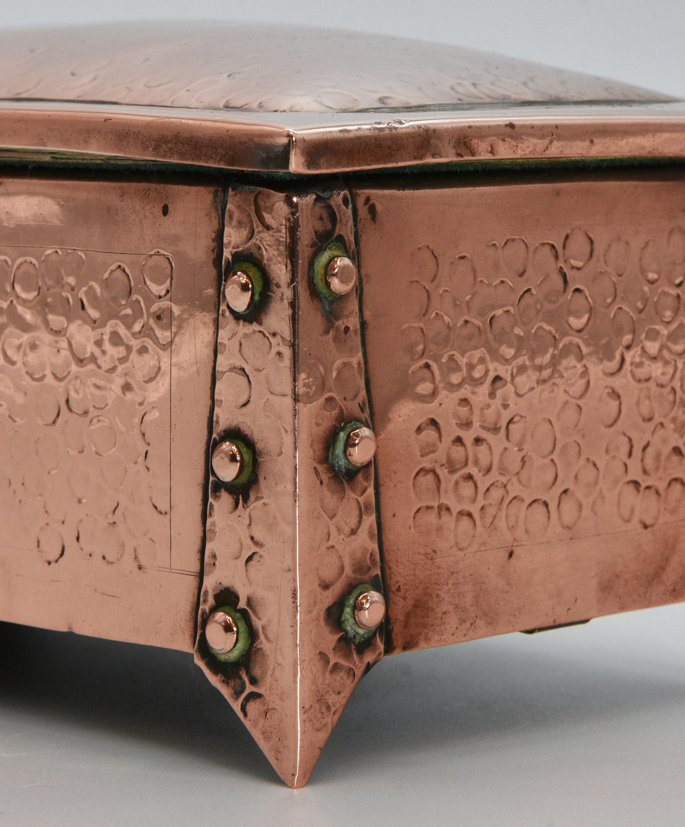 An Arts & Crafts small hand made copper box with rivet strapped legs. Circa 1900.

The interior is lined with baize. This does show signs of use, and may have been added at a later date. There is a slight knock to the right hand side of the top.