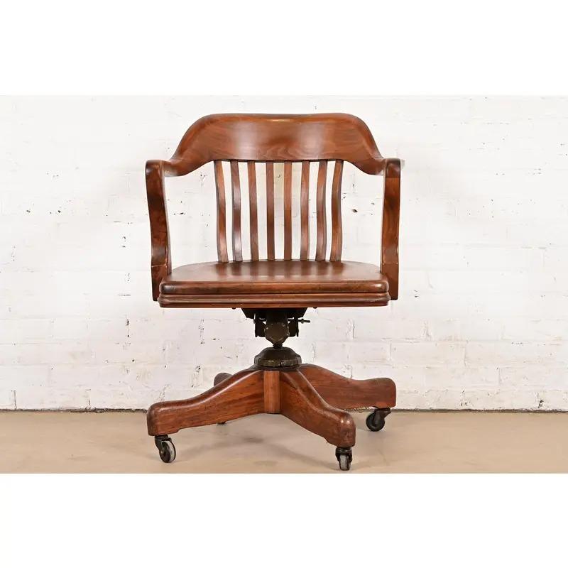 An exceptional Arts & Crafts, Mission, or Mid-Century Modern carved solid walnut executive swivel desk chair

By Johnson Chair Co.

USA, Circa 1940s

Measures: 27.5