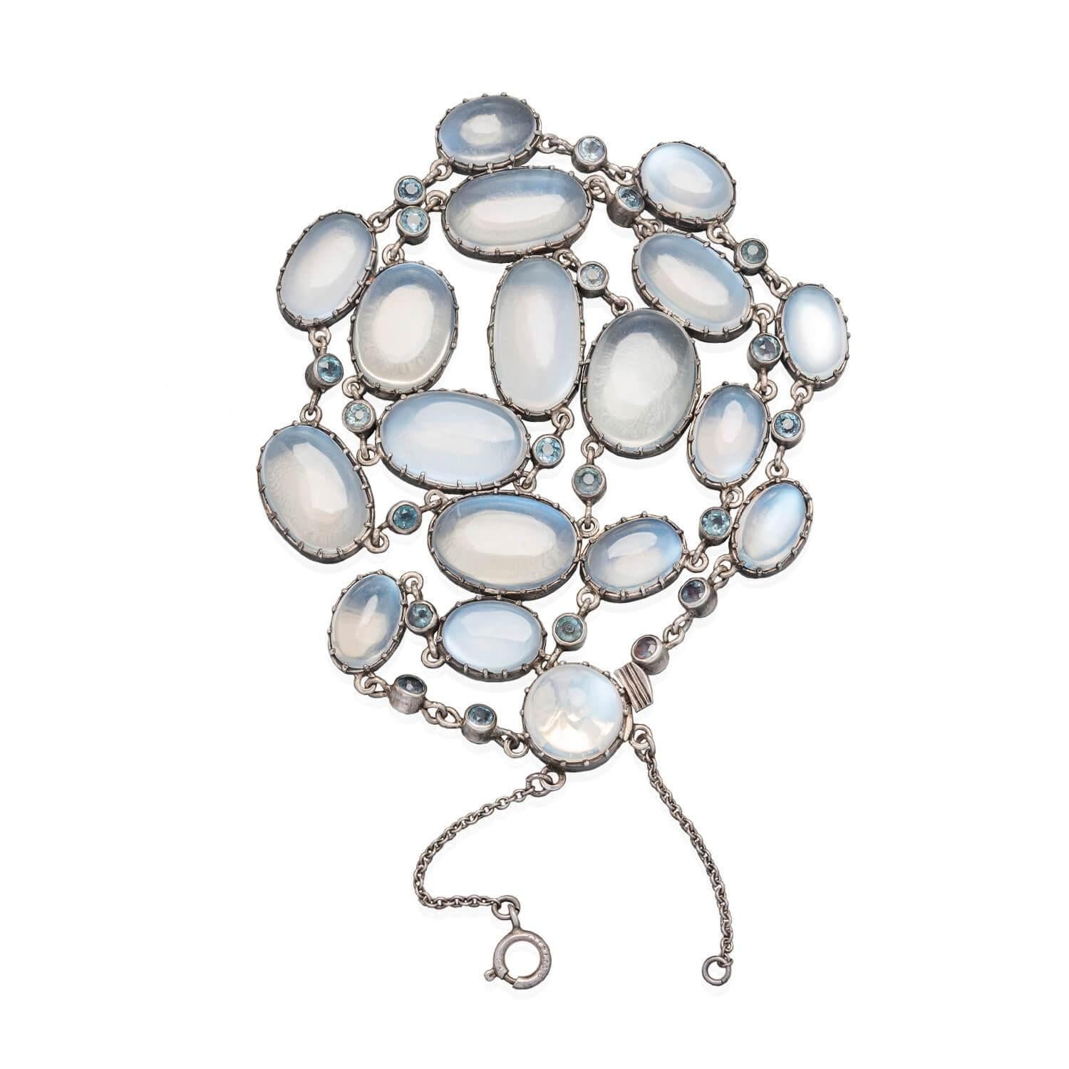 A stunning moonstone necklace from the Arts & Crafts era (ca1910s)! This incredible piece is crafted in sterling silver and comprised of stunning moonstone and blue zircon links. The necklace displays a moonstone chain, graduating slightly in size,