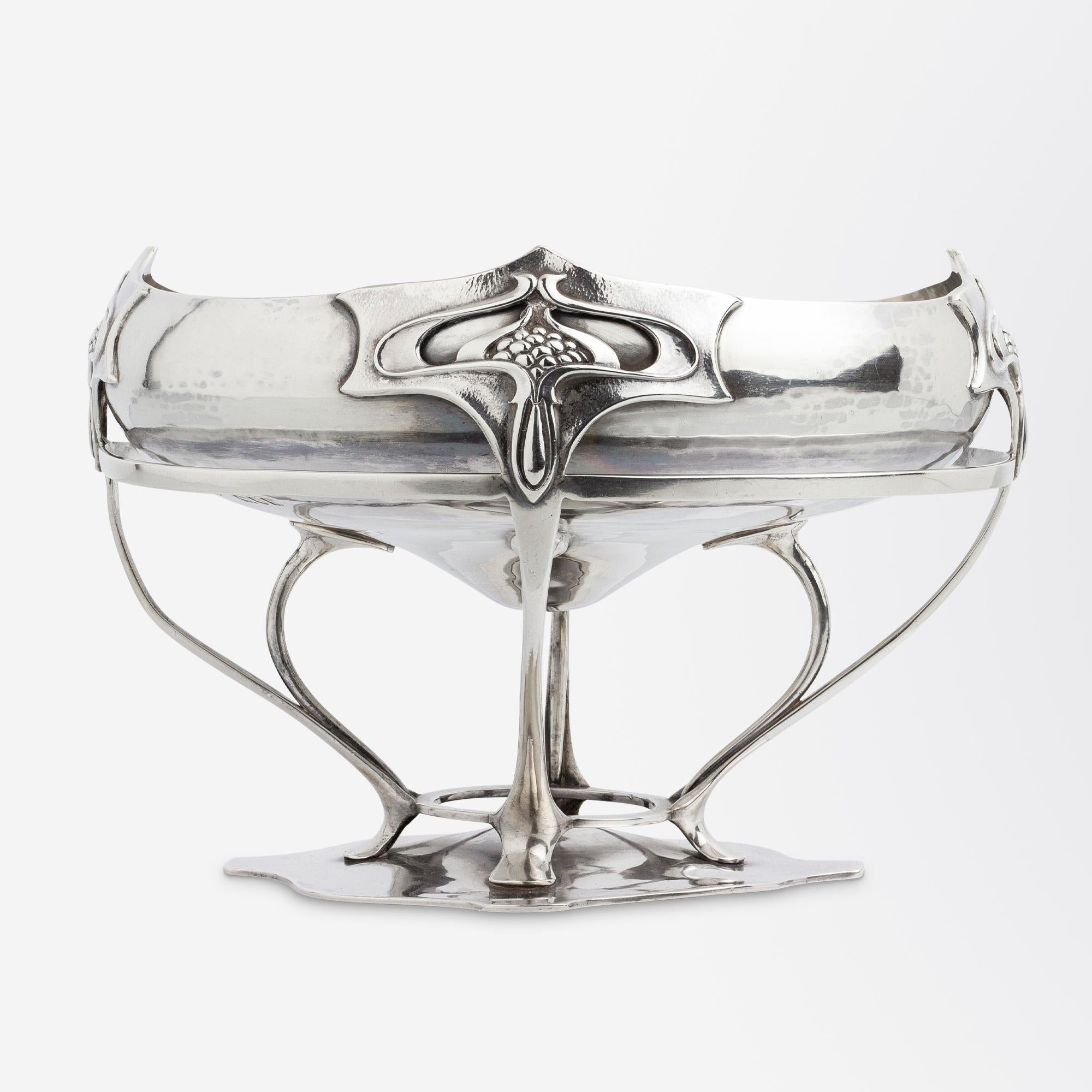 This unusual sterling silver centrepiece could be described as several things - a comport, a jardiniere or simply a footed bowl. Crafted by London silversmith William Comyns & Sons the piece has been assayed for manufacture in 1901, which is both