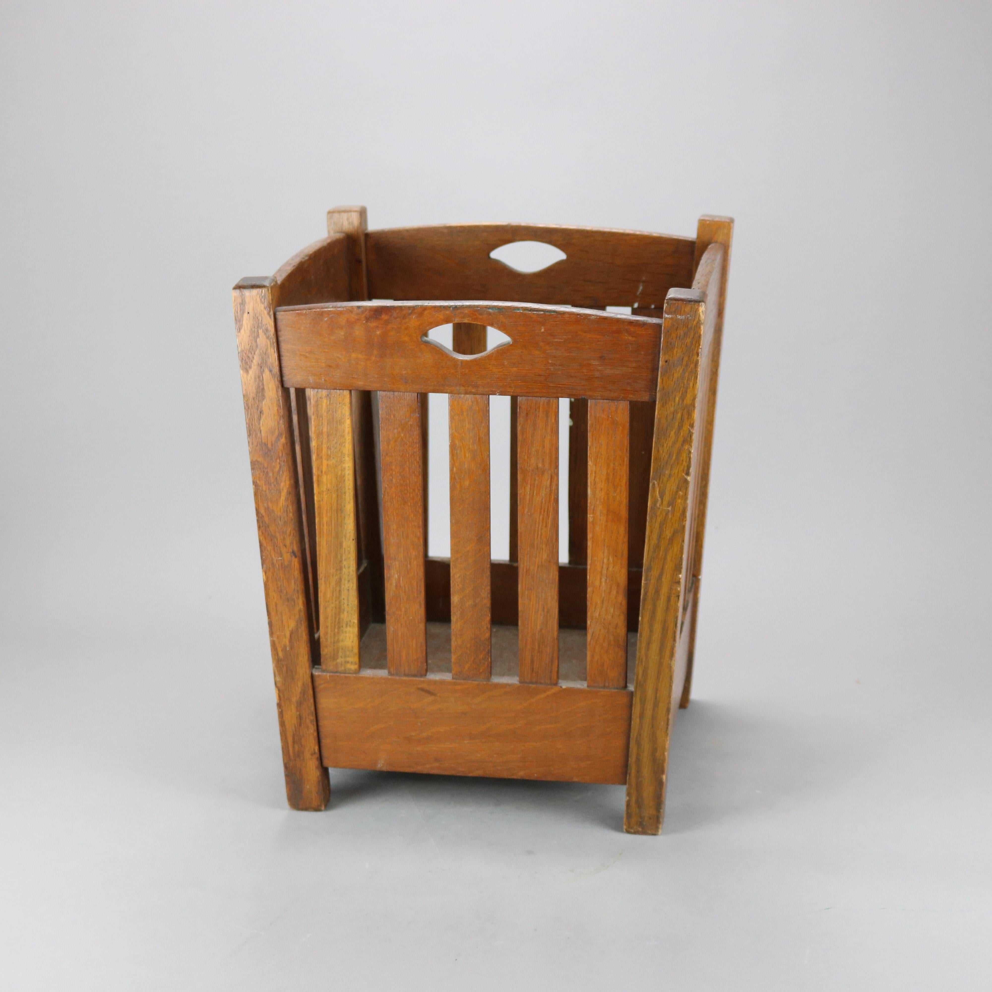 An antique Arts & Crafts waste basket by Stickley Bros, Catalog #101-30, offers oak construction with cutout handles and flared slat sides, c1910

Measures - 17.75'' H x 14.25'' W x 14.25'' D.
