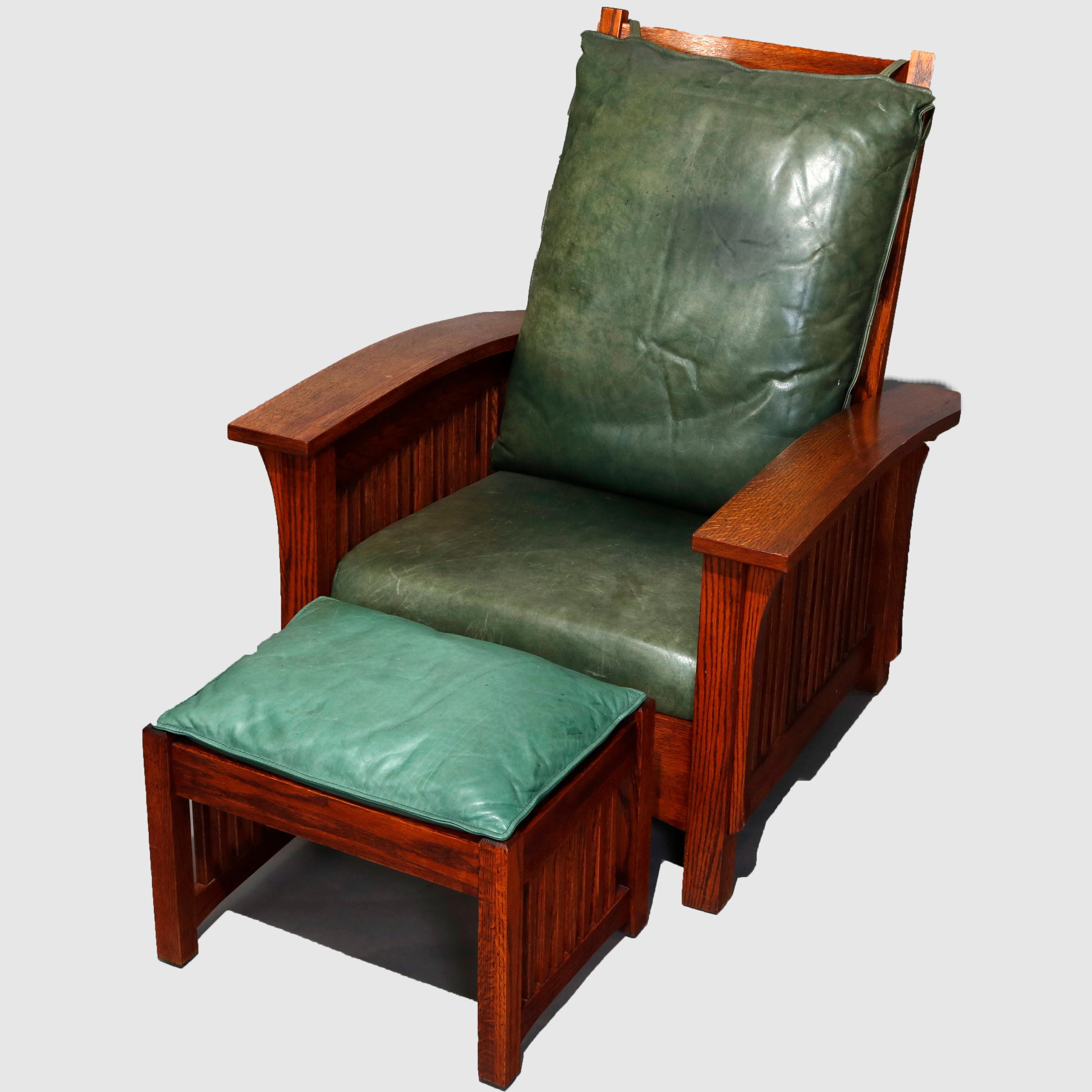 A Mission Oak Morris chair and ottoman in the manner of Stickley Bros. offers reclining back, slat sides and leatherette cushions, 20th century.

Measures - 40.75