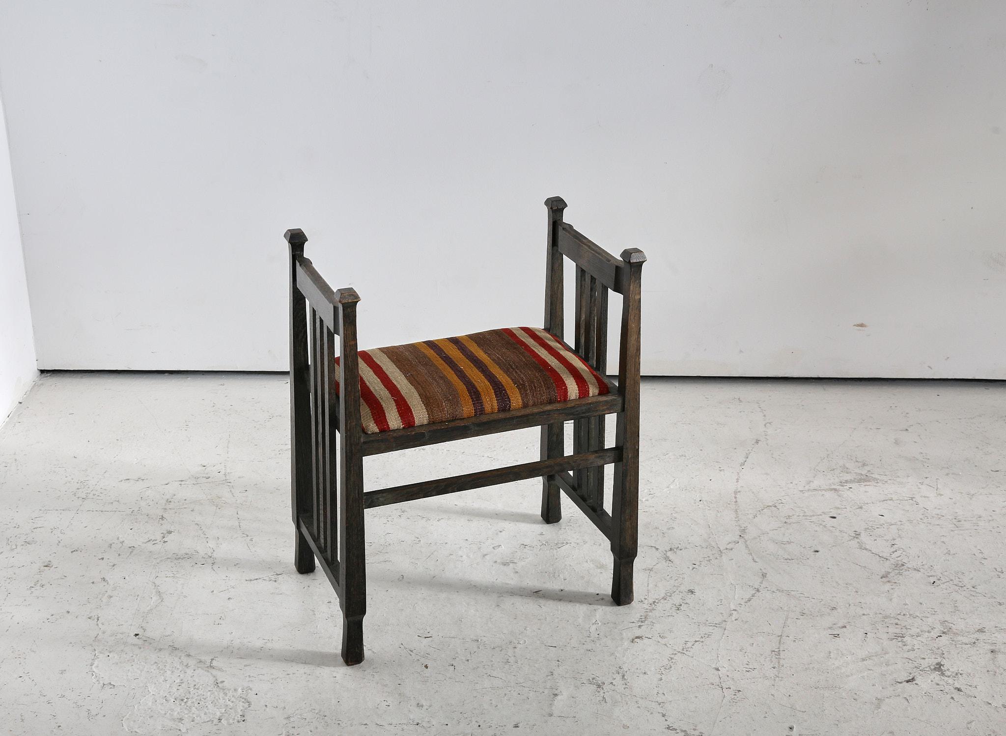 Excellent example of the refined nature of Arts and Crafts design.

This limed oak piano stool was created by one of the movements greats, James Shoolbred circa 1910.

Recently upholstered in period fitting kilim carpet fragment.

England, 1910.

H
