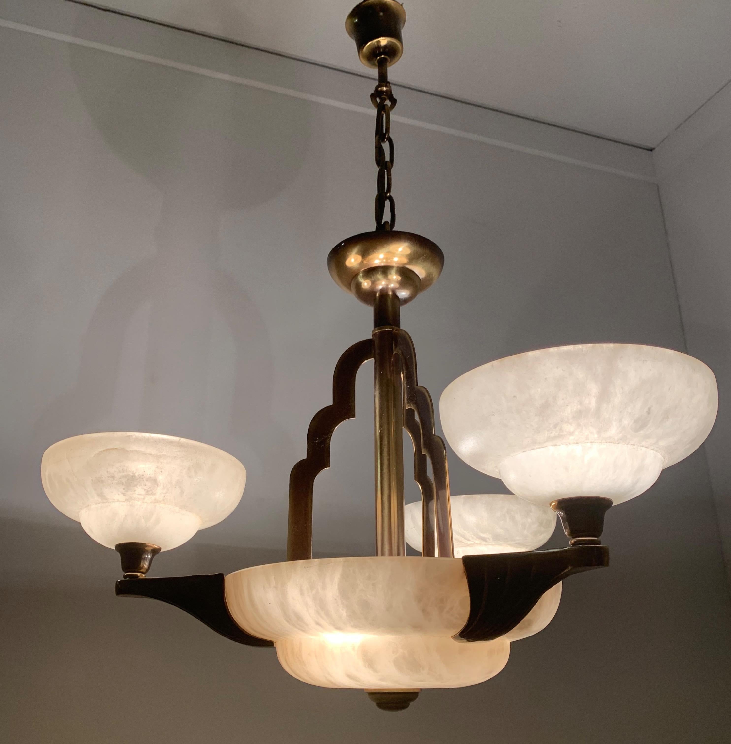 Excellent condition and rare design, 3-arm, 6-light chandelier.

If you like Art Deco light fixtures, but you prefer to have them shiny like new, then this 1970s alabaster and bronze chandelier could be perfect for you. The combination of the white