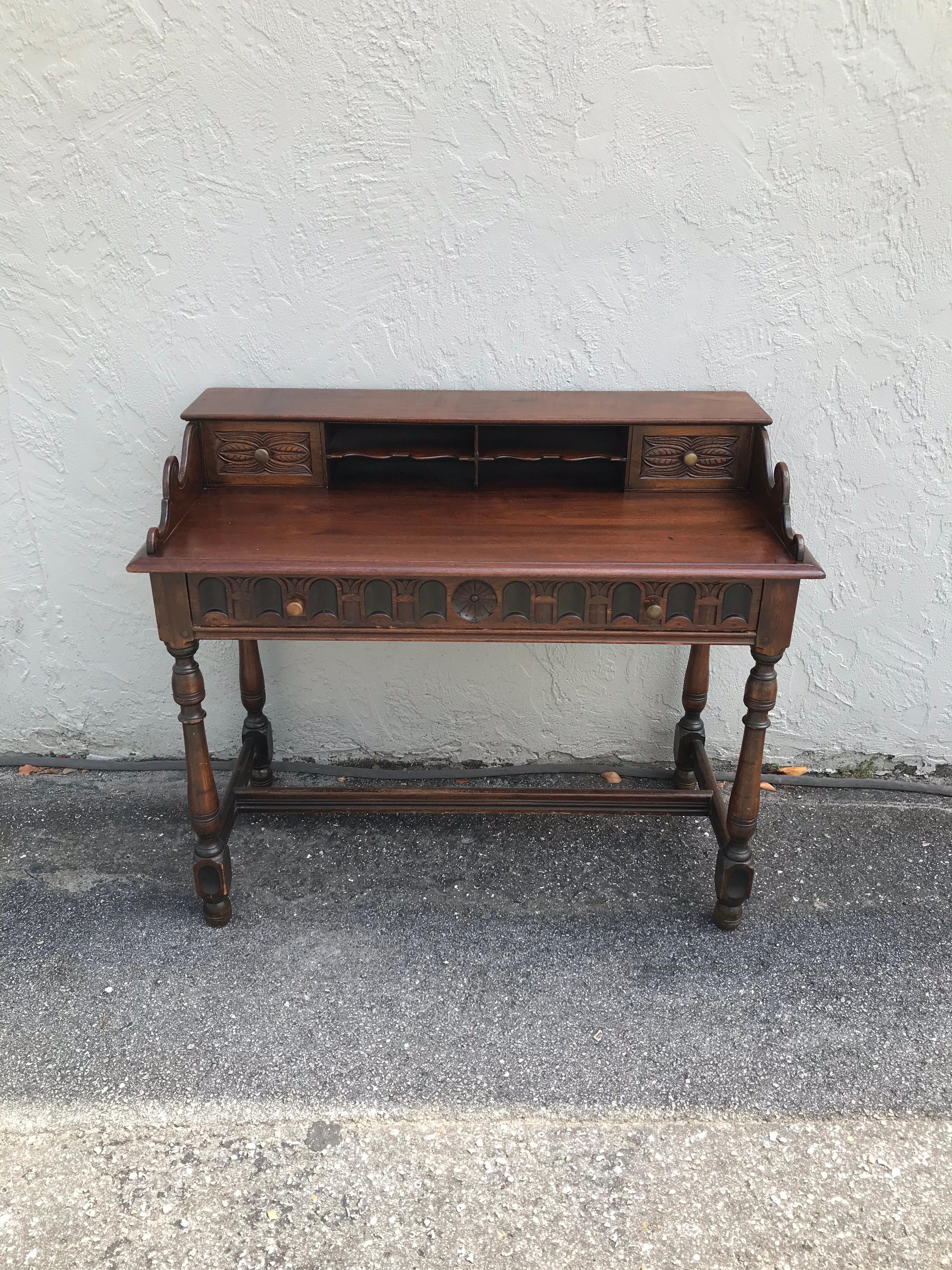 Unique arts & crafts style desk with multiple drawers & compartments. Beautiful carved details on drawer fronts.