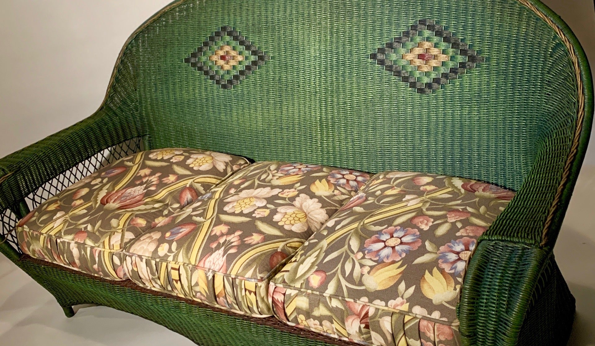 A beautiful three seat, Arts & Crafts style antique wicker sofa in excellent condition. It is attributed to the Karpen Furniture Company of Chicago,Los Angeles,Michigan City and New York. This six legged sofa is in a close hand woven style with a