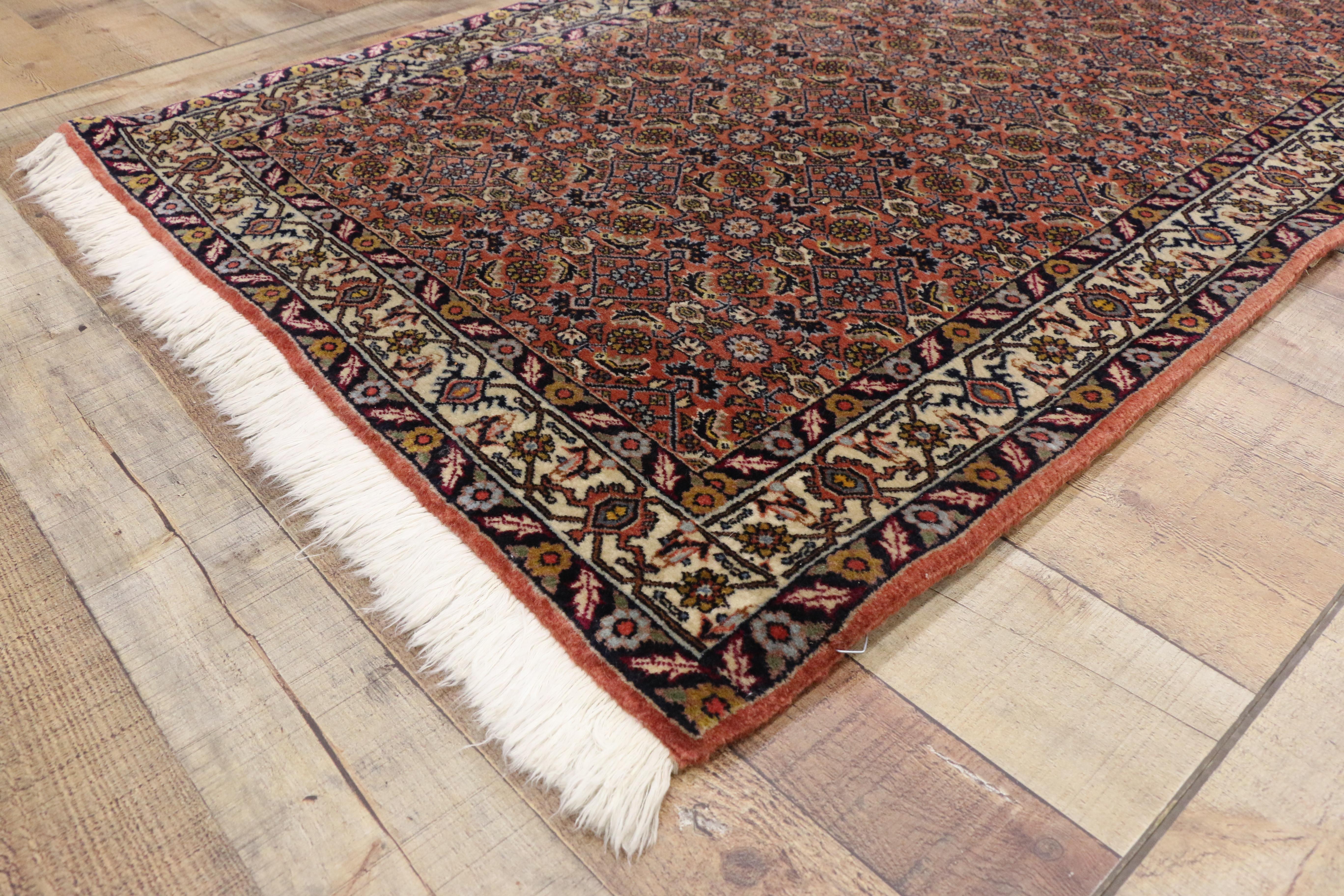 76711, Arts & Crafts Style Vintage Persian Bijar Runner, Hallway Runner. This hand-knotted wool Persian runner features a repeated geometric print composed of an all-over Herati pattern to the entirety of the field. It is framed with alternating