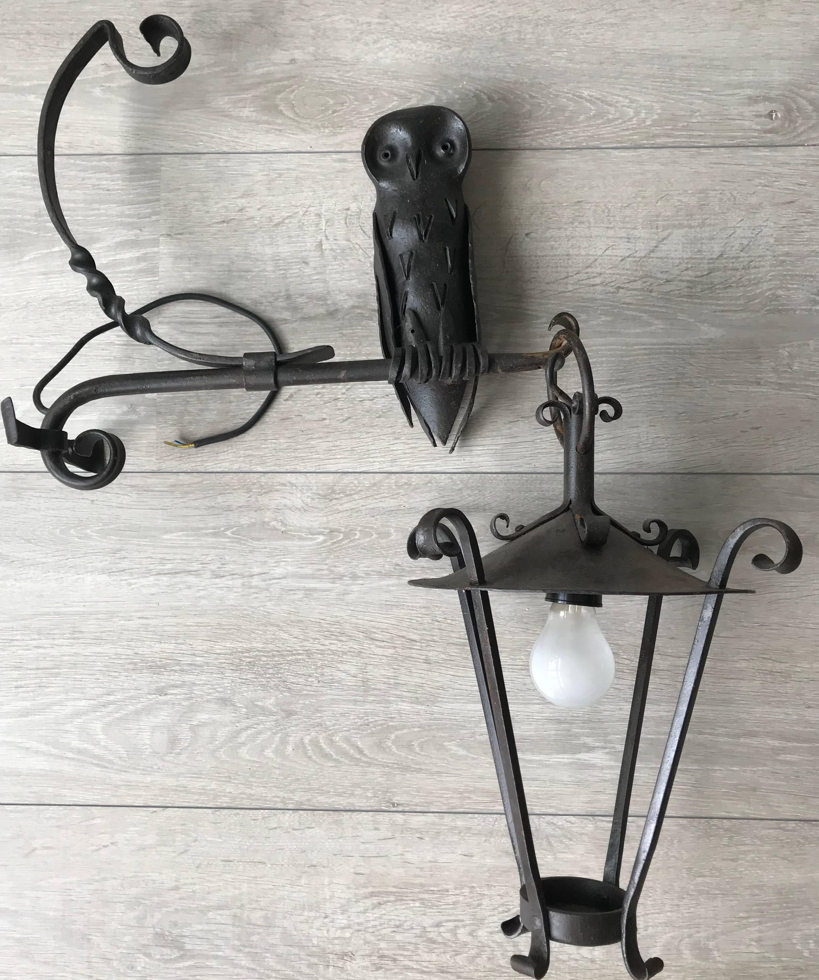 Handcrafted and unique outdoor wall lantern with sculpture.

This all-handcrafted work of lighting art is the only one of its kind and it is in amazing condition. This mid-20th century made wall sconce comes with a beautiful and entirely hand-forged