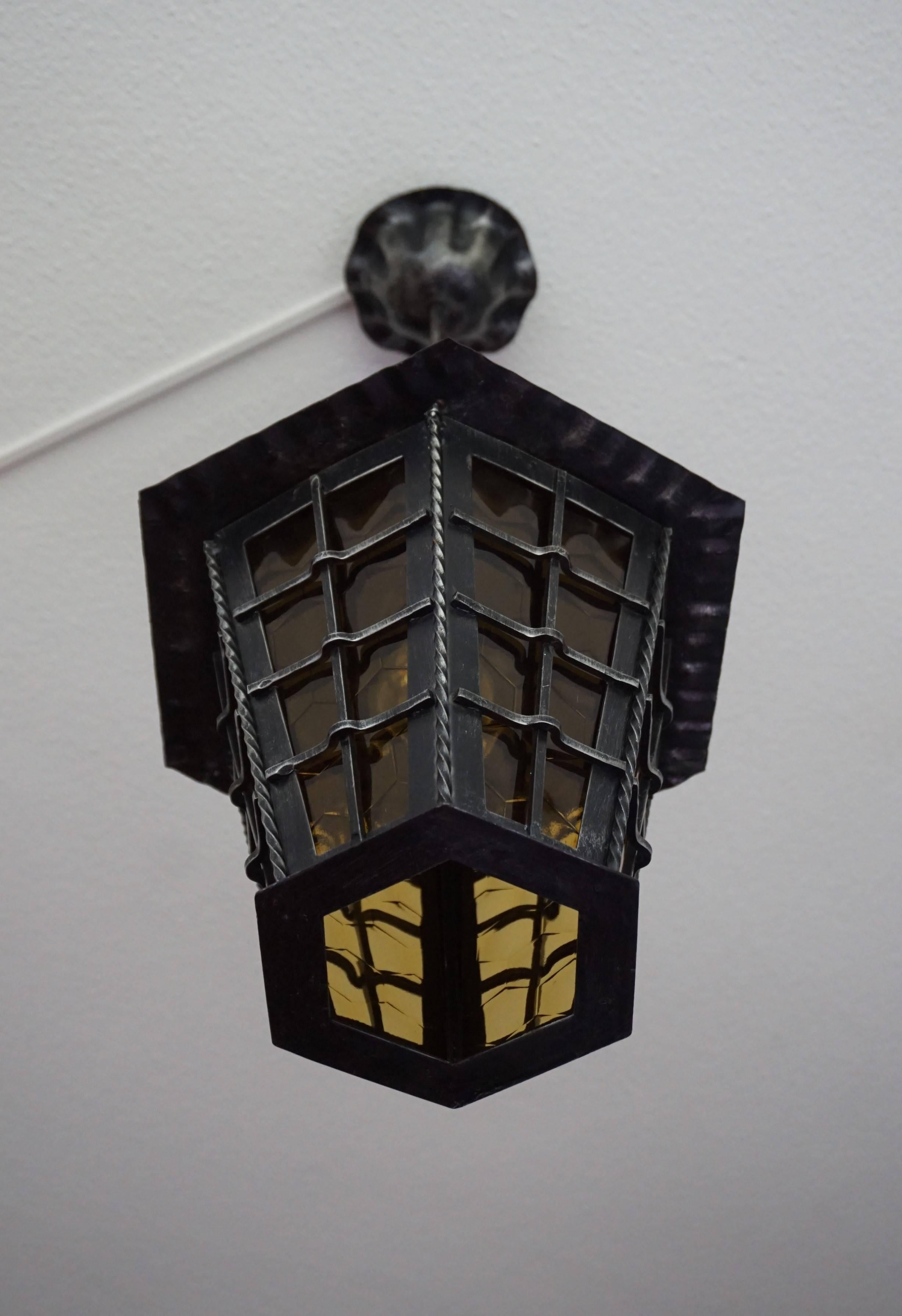 Handcrafted and great atmosphere creating lantern/pendant.

We have sold hexagonal shaped pendants before, but never one that is like a stylized beehive. The honeycomb pattern and color of the inserted glass panels combined with the hexagonal bottom