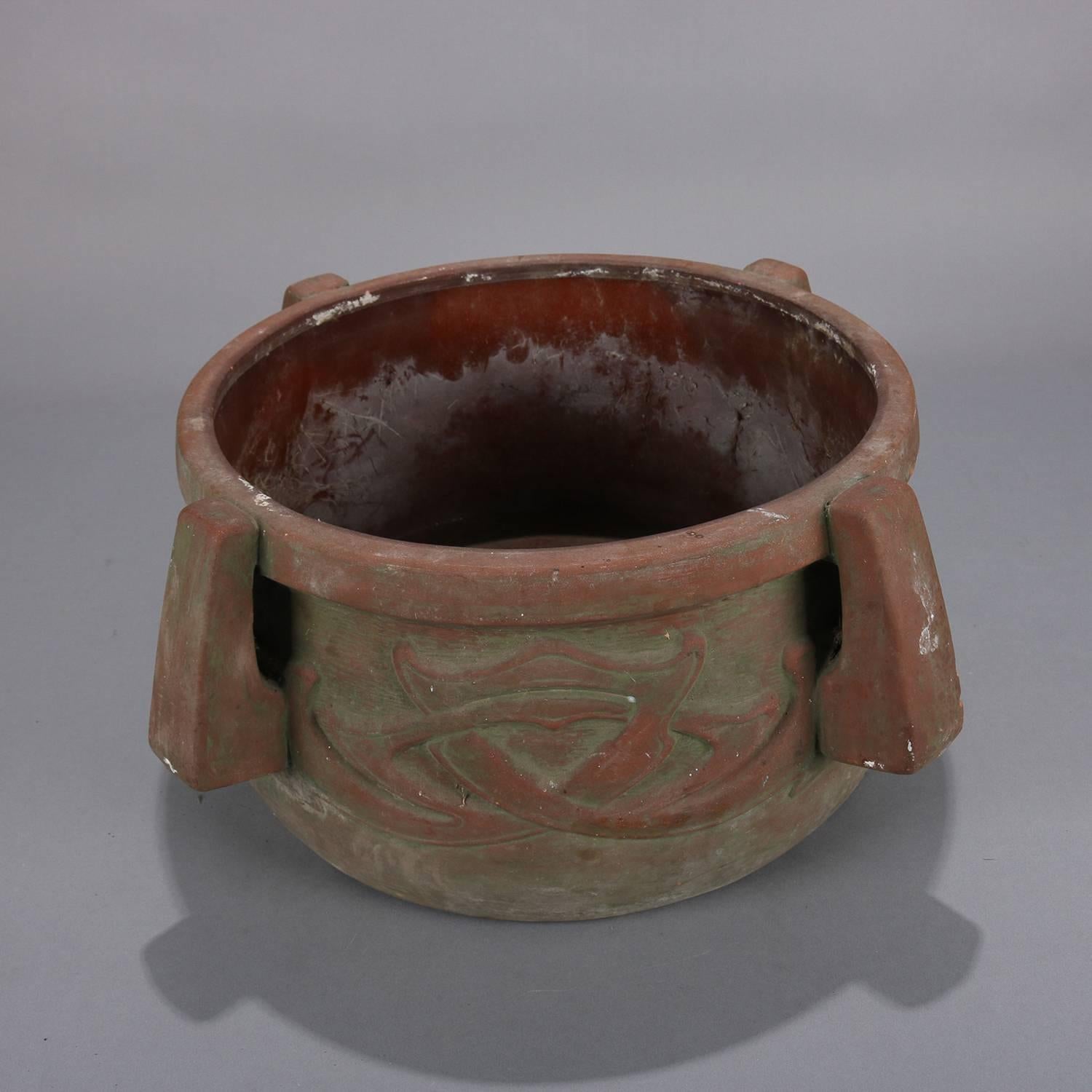 Arts & Crafts terracotta planter features high relief abstract decoration with four handles, circa 1910

Measures: 9