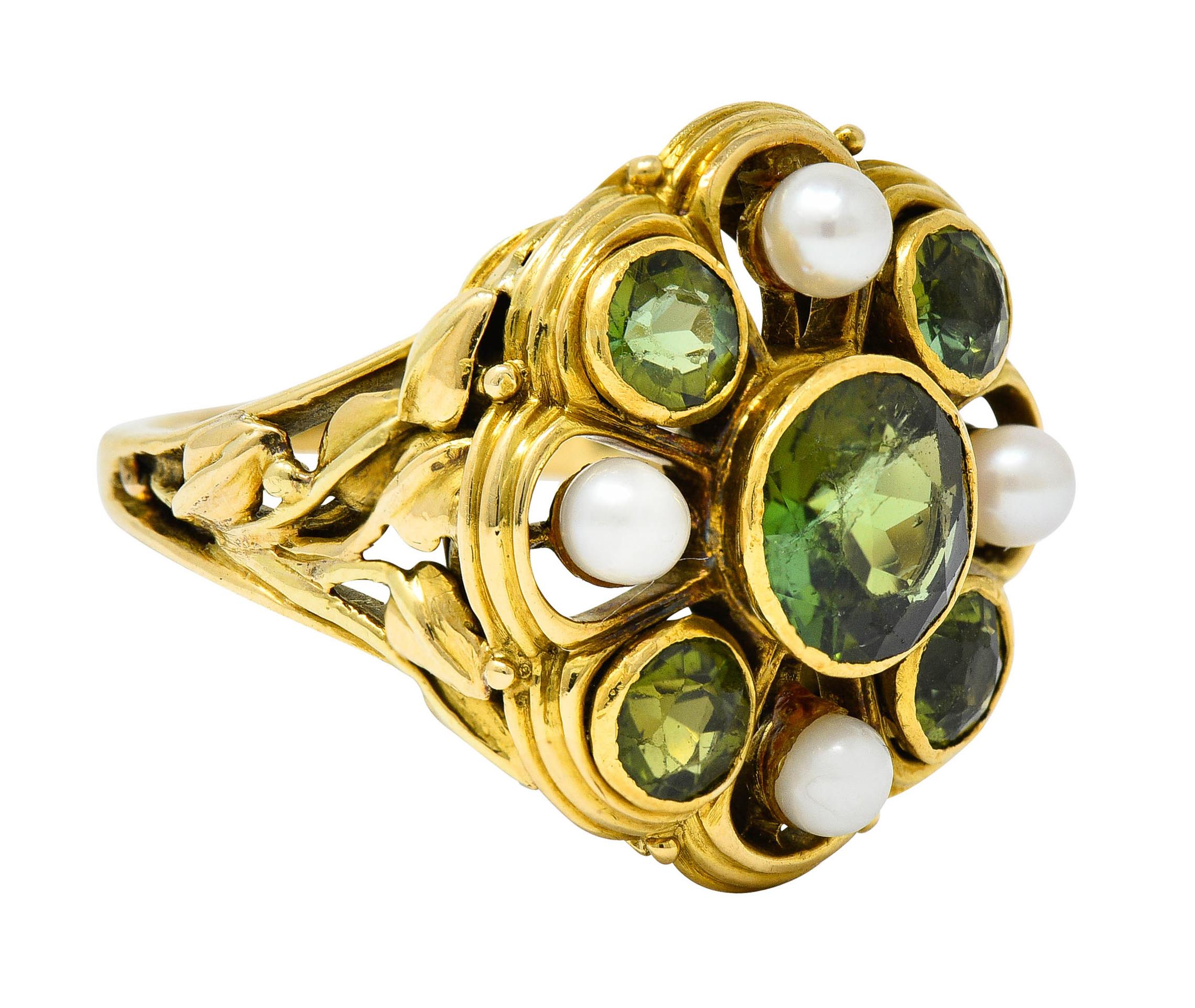 Designed as a circular cluster ring bezel set with five round cut tourmalines

Measuring from 7.8 mm to 4.0 mm with very well matched yellowish green color

Alternating with 3.2 mm round pearls - well matched white body color with good to very good