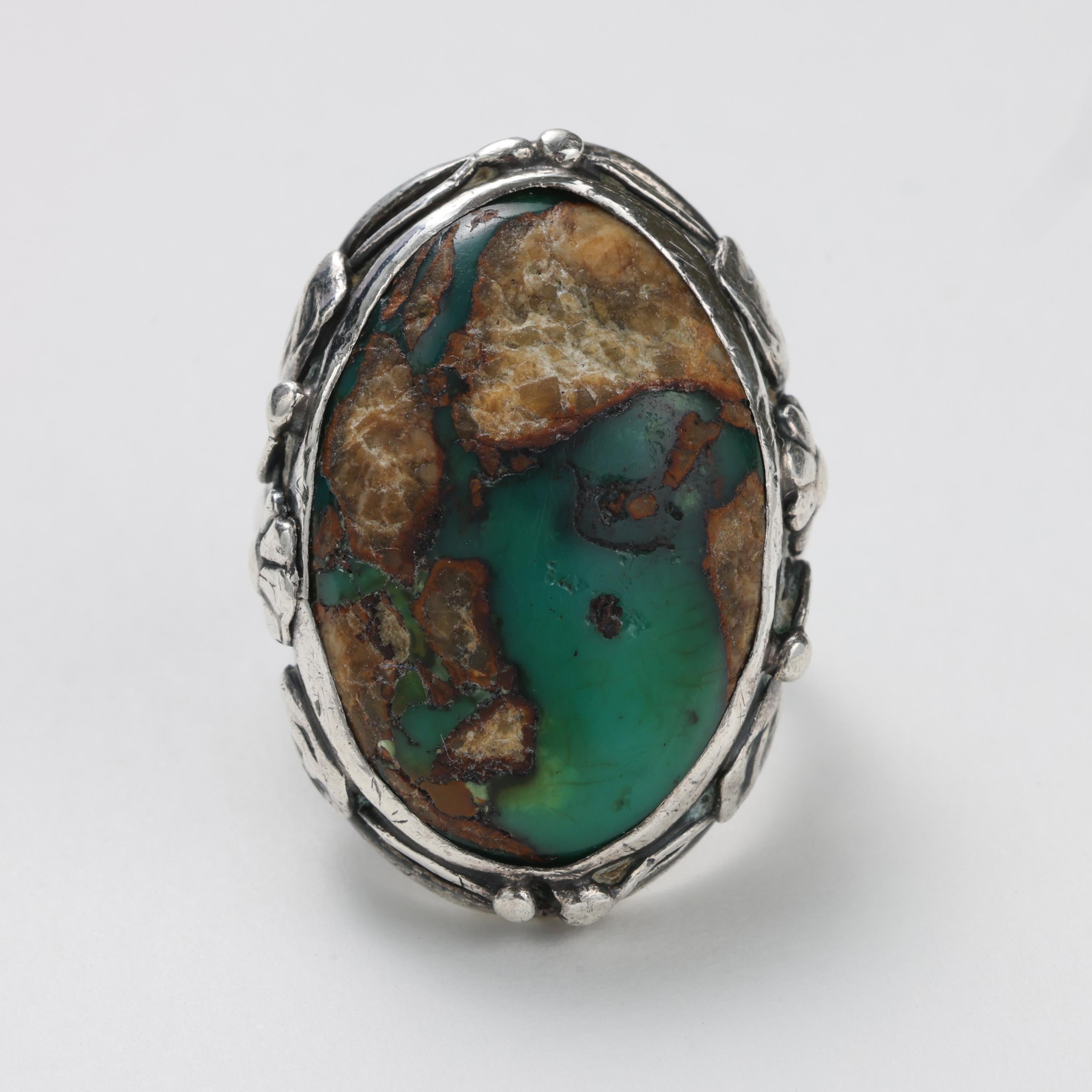 This is a gorgeous Arts & Crafts movement turquoise and silver ring entirely hand-crafted -from the cabochon to the mounting- most likely by a single individual, as was often the case with jewelry from this era. The Arts & Crafts movement was a