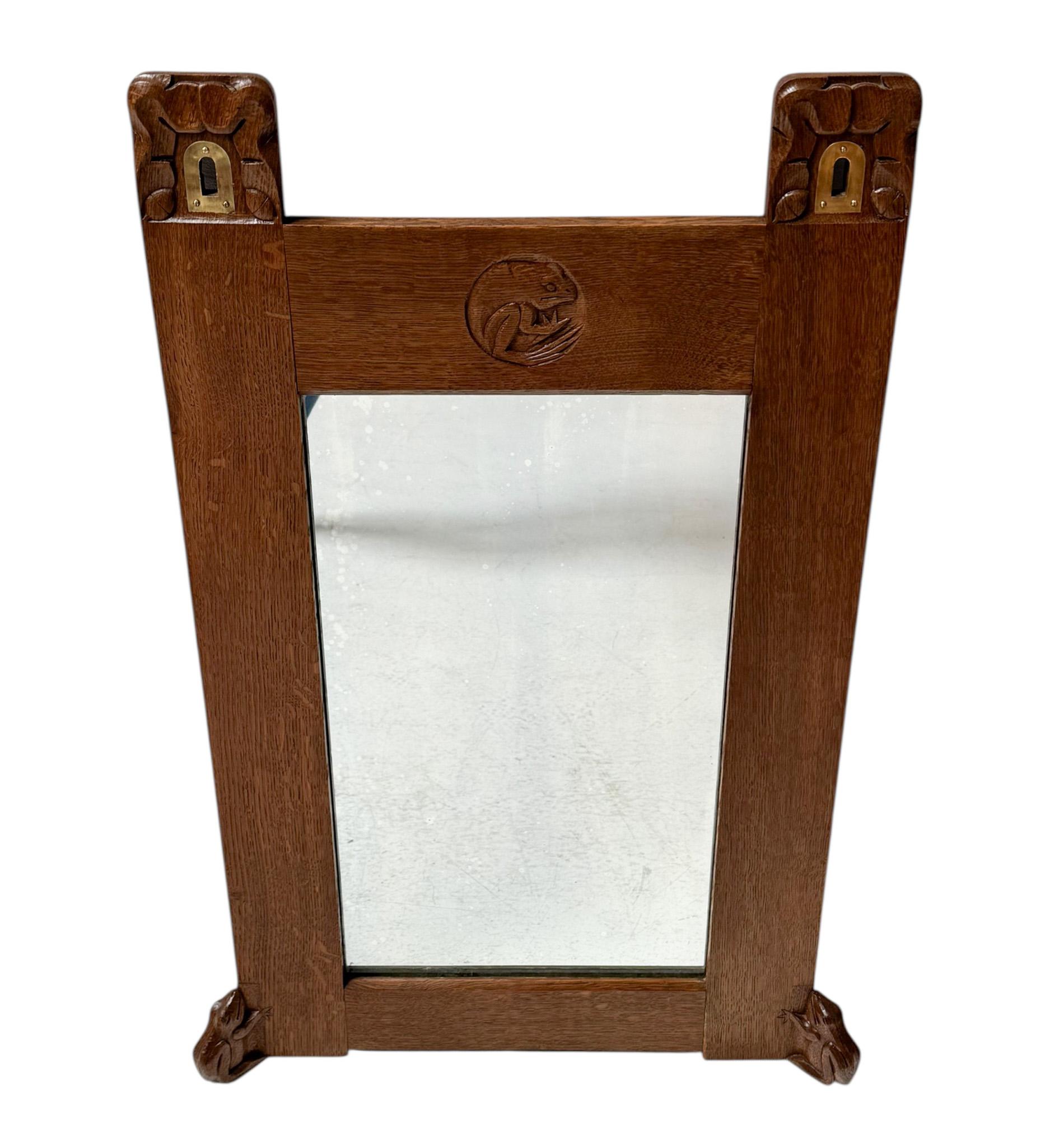 Magnificent and ultra rare Arts & Crafts wall mirror.
Design by Kobus de Graaff.
Striking Dutch design from the 1900s.
Solid oak frame with three original hand-carved frogs.
Original mirror and two original brass openings integrated in the frame for