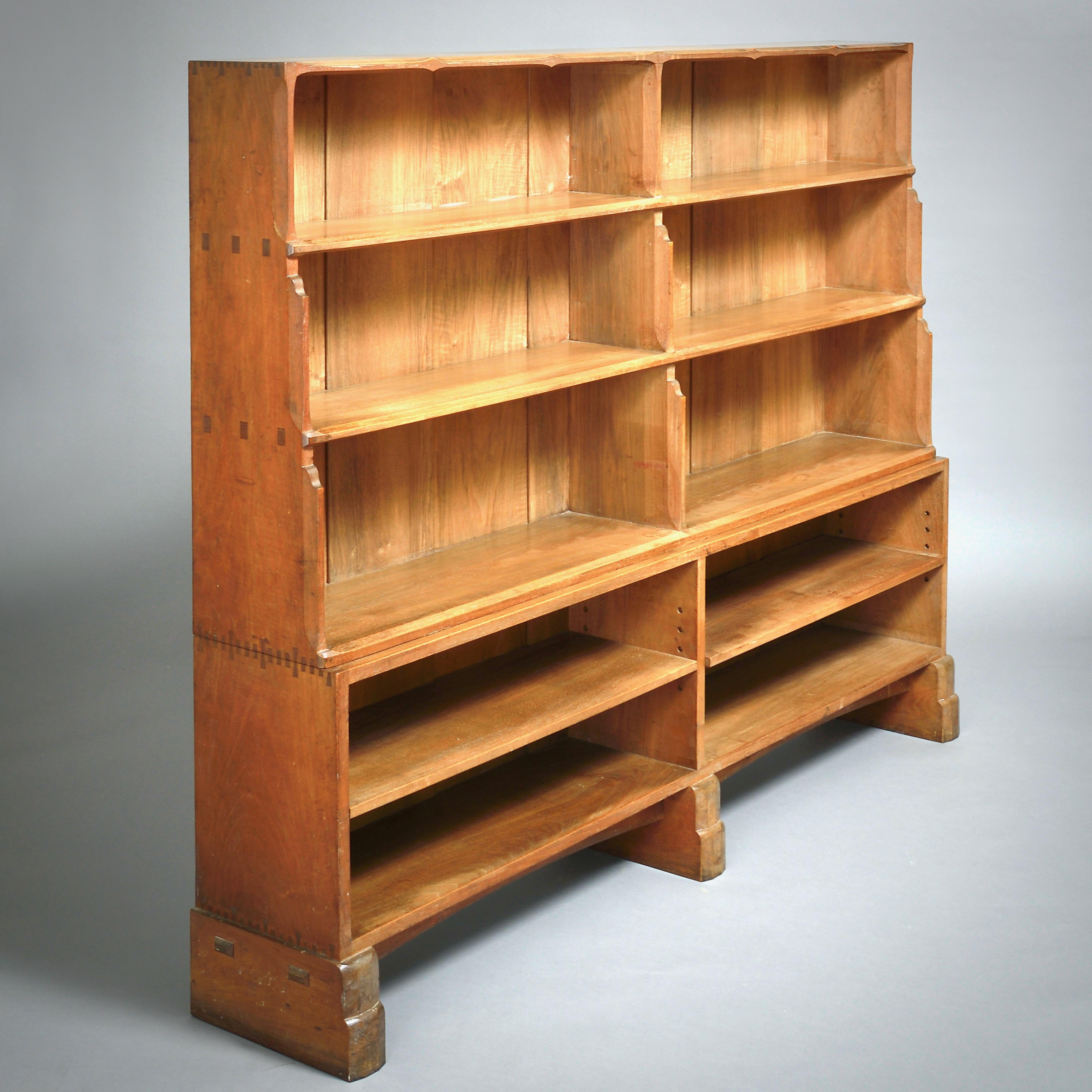 A FINE ARTS & CRAFTS WALNUT BOOKCASE ATTRIBUTED TO ERNEST GIMSON, CIRCA 1910.

With fine chamfered detailing throughout and exposed tenons and dovetails.