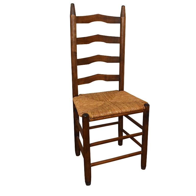 A fabulous set of Arts and Crafts rush seat, ladder back wooden chairs. This set will be great in a dining room, breakfast table, or as an accent chair in a living room or bedroom. Each chair has four horizontal pieces of wood on the ladder backs.