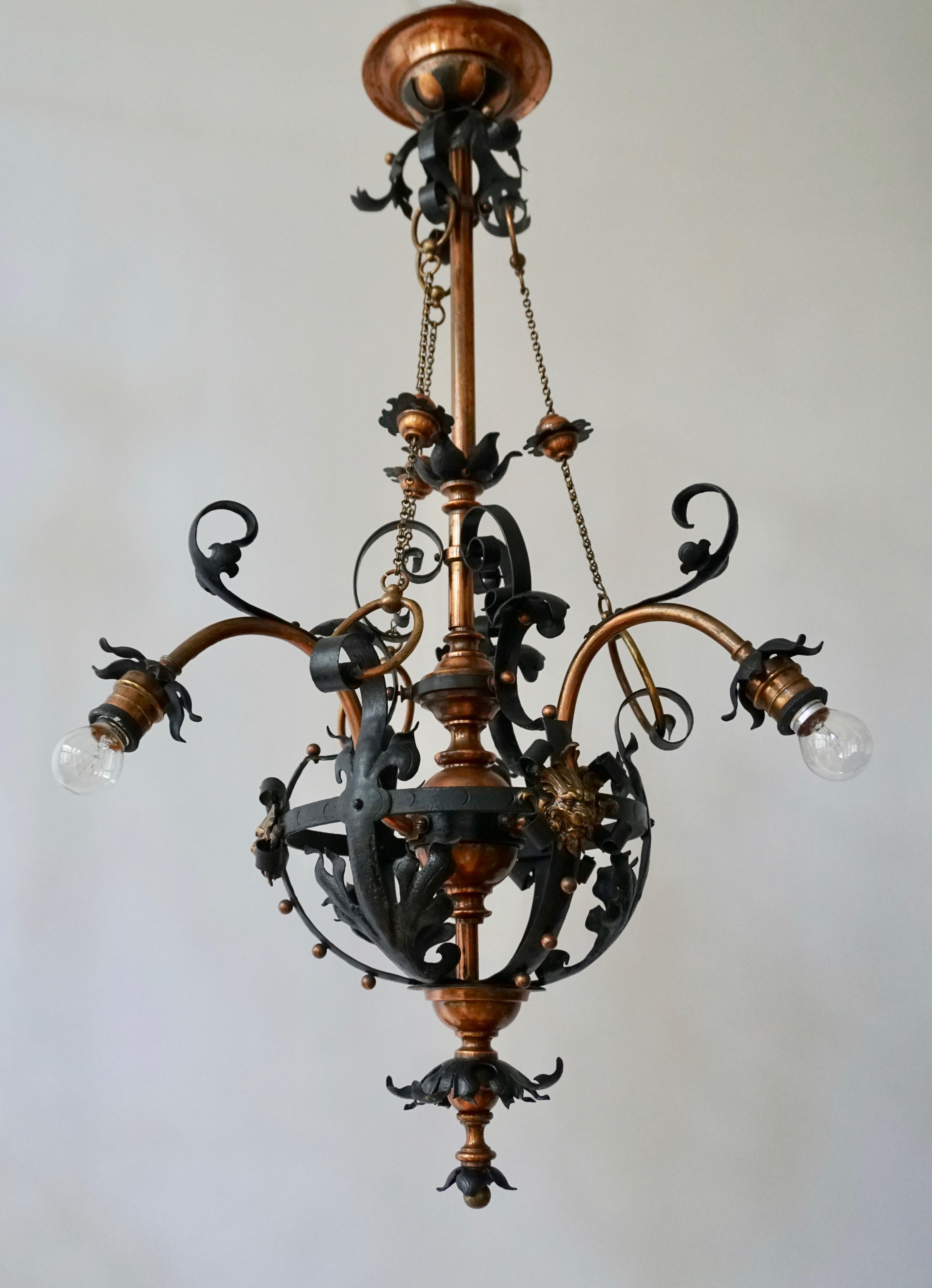 Rare Arts & Crafts wrought iron and copper chandelier with beautiful bronze lion heads.

This large and all-handcrafted chandelier is another one of our recent great finds. The beautiful shape and the many details make this one of a kind