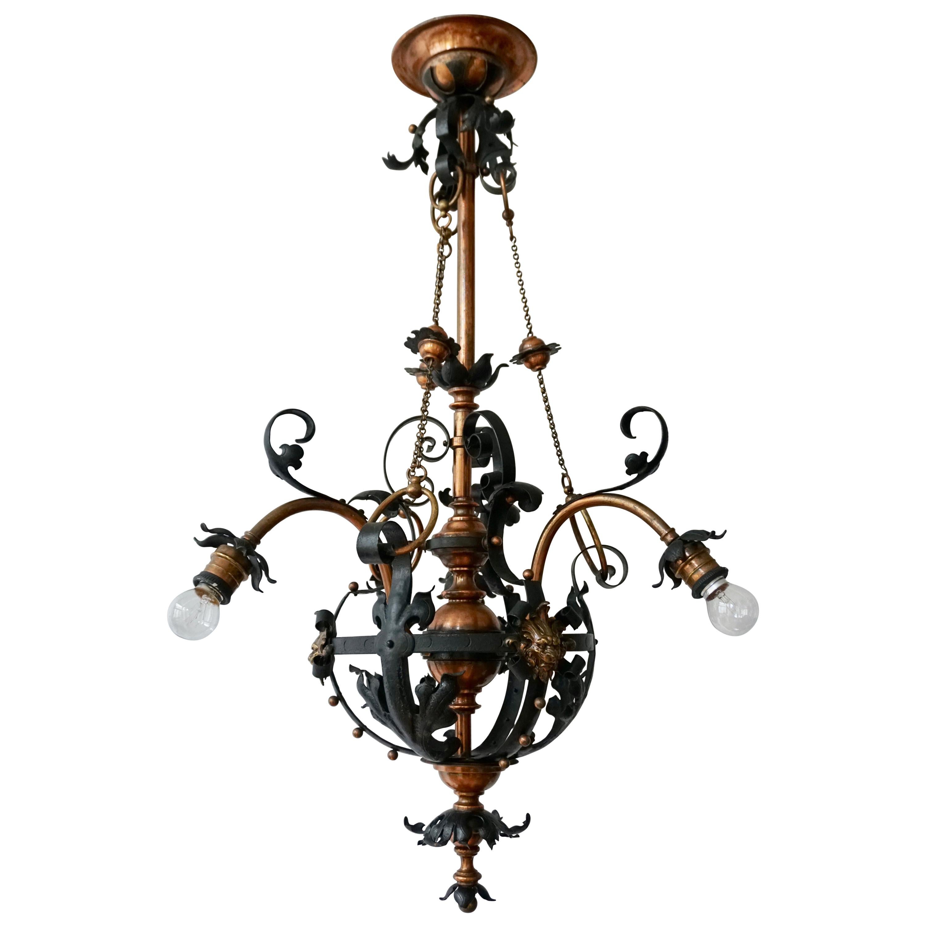 Arts & Crafts Wrought Iron and Copper Castle Chandelier with Bronze Lion Heads For Sale