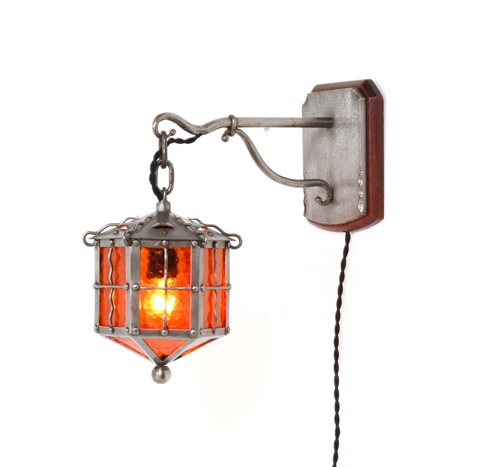Stunning and rare Arts & Crafts wall light or sconce.
Striking Dutch design from the 1900s.
Original patinated wrought iron frame with original hand-blown glass.
Rewired with one original socket for E-27 light bulb.
This wonderful Arts & Crafts wall