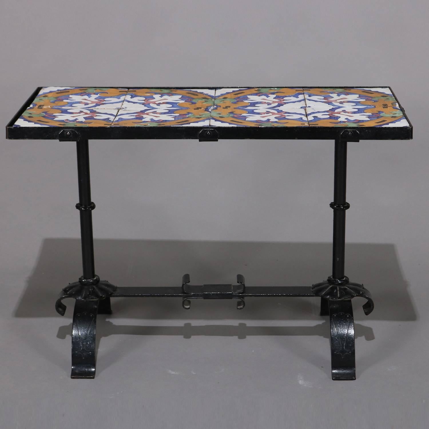 Arts & Crafts Yellin school table features wrought iron construction in trestle form with California stylized floral enameled tile top, circa 1920.

Measures: 22