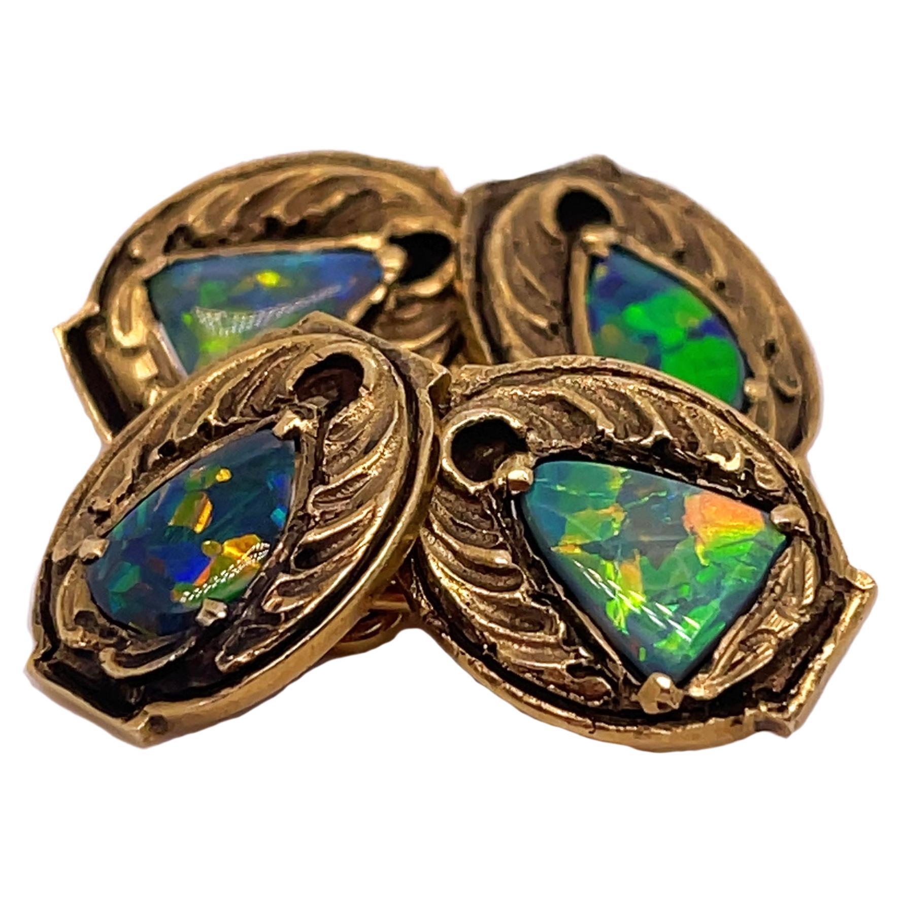 This is a spectacular pair of Arts & Crafts cufflinks signed by Walton & Co featuring gorgeous centerpieces of solid black opal. The detailing on these cufflinks is incredible, and the brilliant dimension of the black opal is the perfect complement