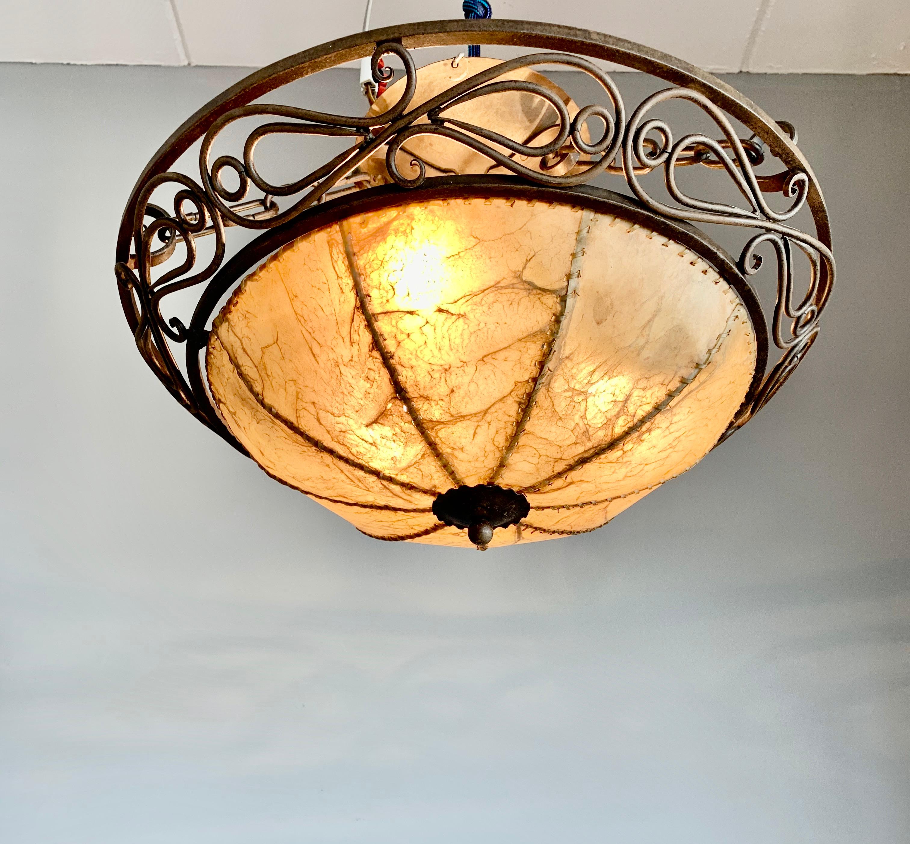Stylish and handcrafted Arts and Crafts ceiling lamp.

This spherical and manly ceiling lamp is entirely handcrafted of strong, lasting and natural materials. The shade of animal hide gives this lamp it's warm and rustic look. This lamp comes with a