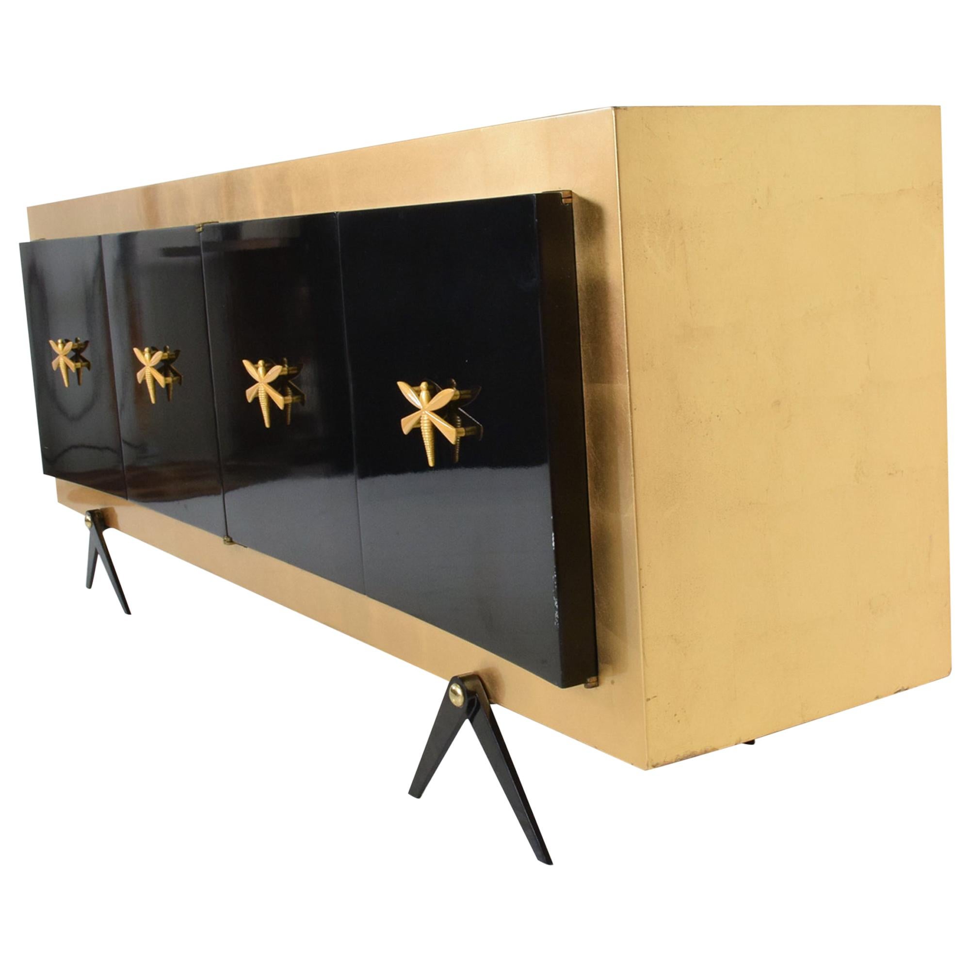 Credenza
Midcentury Mexican Modernist Stunning Custom Dragonfly adorned Credenza, attribution Arturo Pani.
Spectacular splayed legs
Unmarked. Mexico 1950s.
Sensational Bronze pull handles on four doors. 
Open shelf storage, no drawers. 
90.63 L x 21