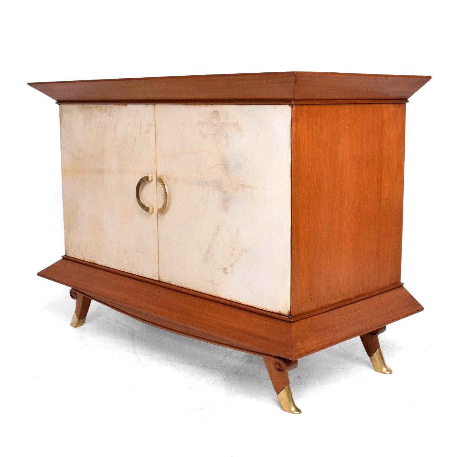 For your consideration a Mexican modernist cabinet attributed to Arturo Pani, Mexico, circa 1950s. Mahogany wood with sculptural brass sabots and door pulls and parchment covered doors and top.

Unique design. 

Measures: 35