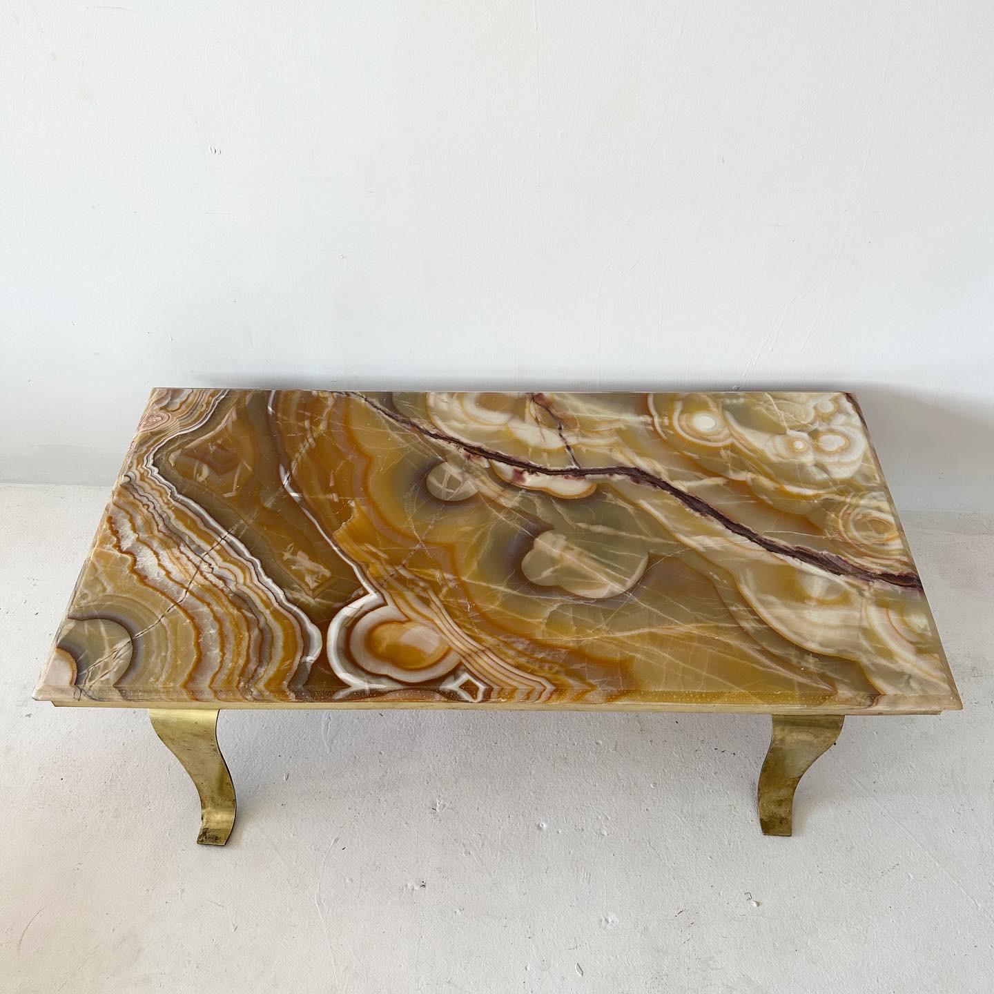1960s Arturo Pani for Muller of Mexico alabaster coffee table with brass trim and winged legs. Often described as onyx, the surface has just been given a matte refinish. Made in Acapulco. Wear consistent with age.