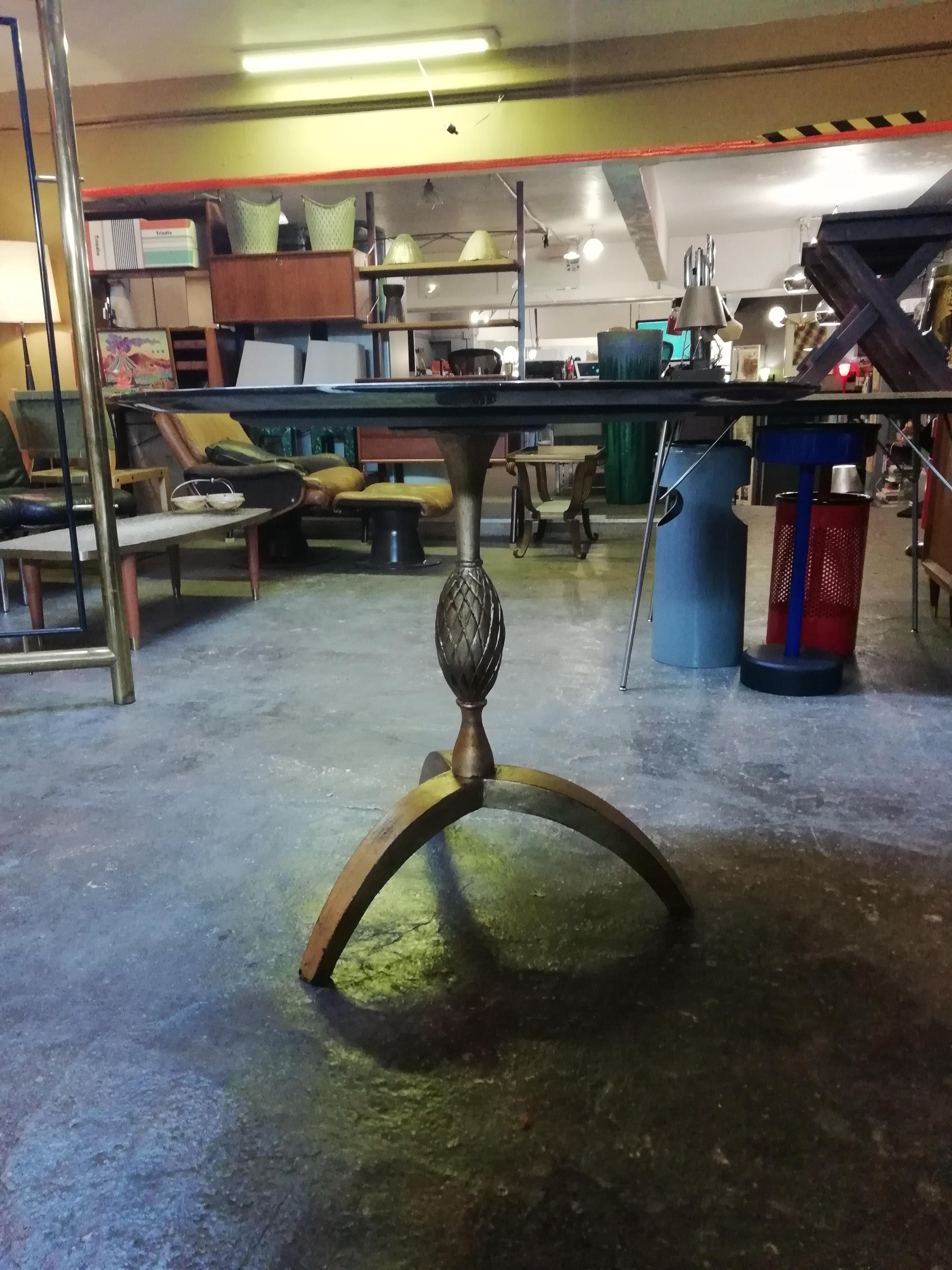 Elegant Mid-Century Modern gilded iron dining table with round black marble top by Mexican designer Arturo Pani. The table's shank shows a strobilus shaped design and rounded legs. The marble top is a contemporary addition.