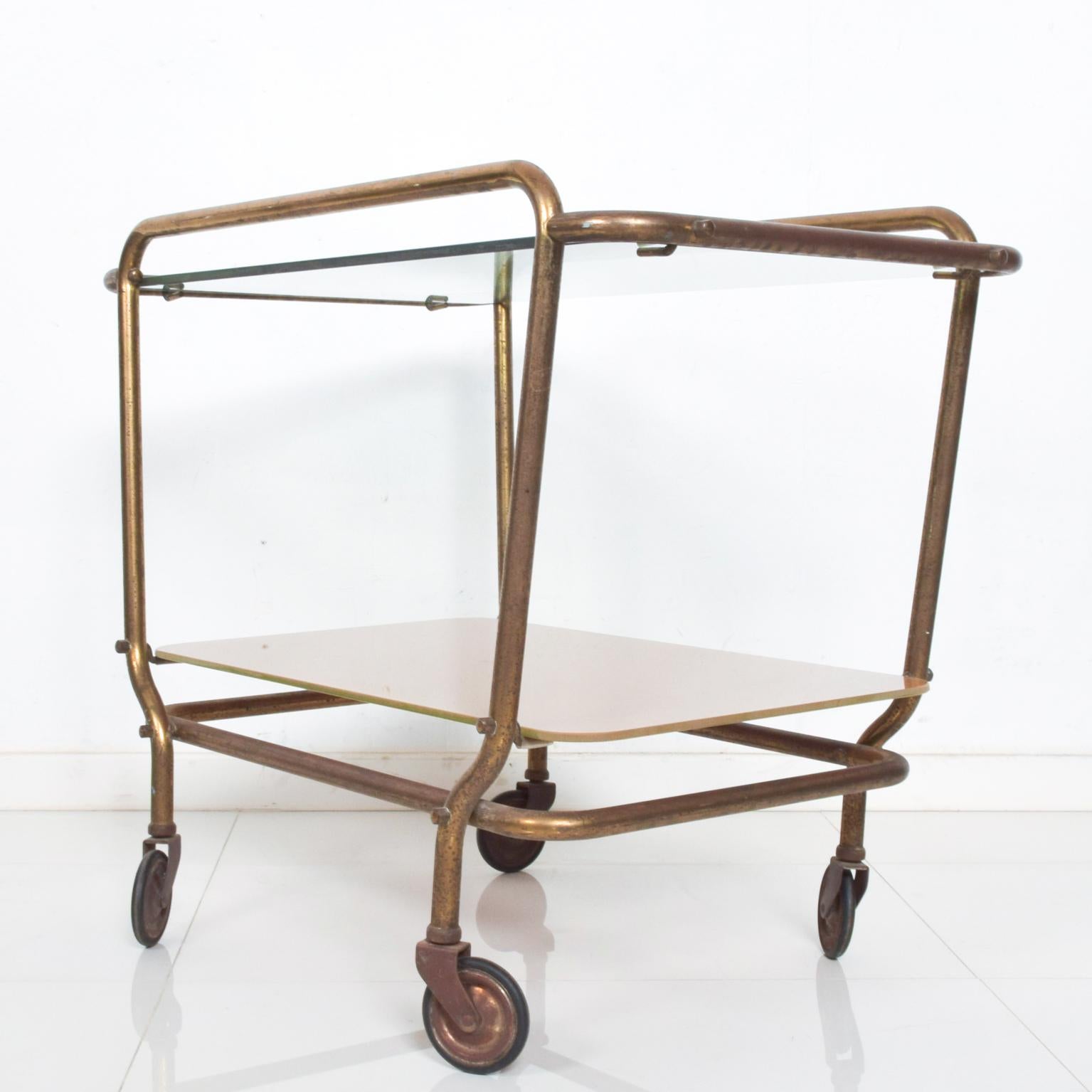 For your consideration: a lovely vintage modern Mexican brass service cart by Arturo Pani.

Body constructed with tubular brass frame. Original vintage wheels, cart features a new glass top. 

Vintage presentation, Mid-Century Modern, 1950s,