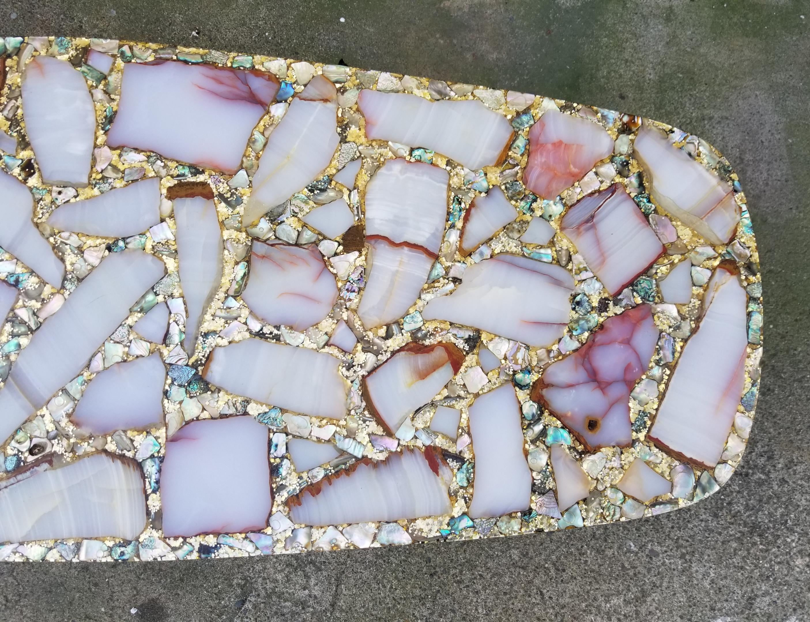 Extraordinary Arturo Pani Hollywood Regency coffee table comprised of onyx stone, abalone shell, gold glitter and resin. Attention grabbing glamorous table making a statement to any interior. Excellent original condition.
