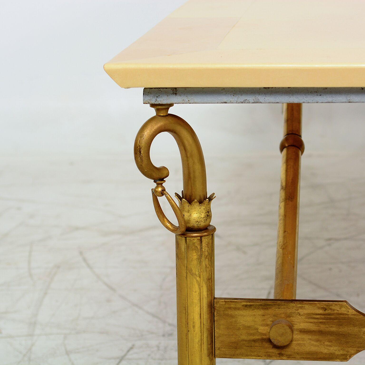 Sculptural Table
Coffee table designed by Arturo Pani. Sculptural and decorative brass frame with parchment top.
Brass has original patina. Leather parchment top has wrinkles indicating vintage wear.
Top has been restored. Some areas of leather top