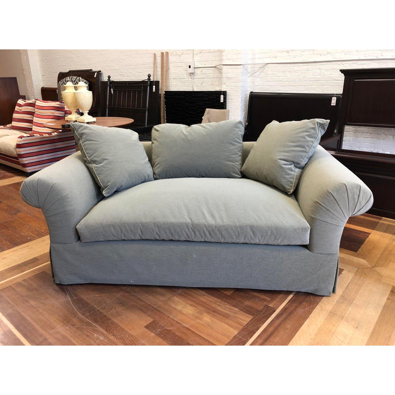 A custom lounge sofa by A. Rudin. A rolled arm deep luxe depth for comfort. Upholstered in Rogers & Goffigon- Hash Stone Dust fabric. The trimming of the pillows are a Samuel & Sons Warwick Twist for with tape. A single seat cushion accompanied with