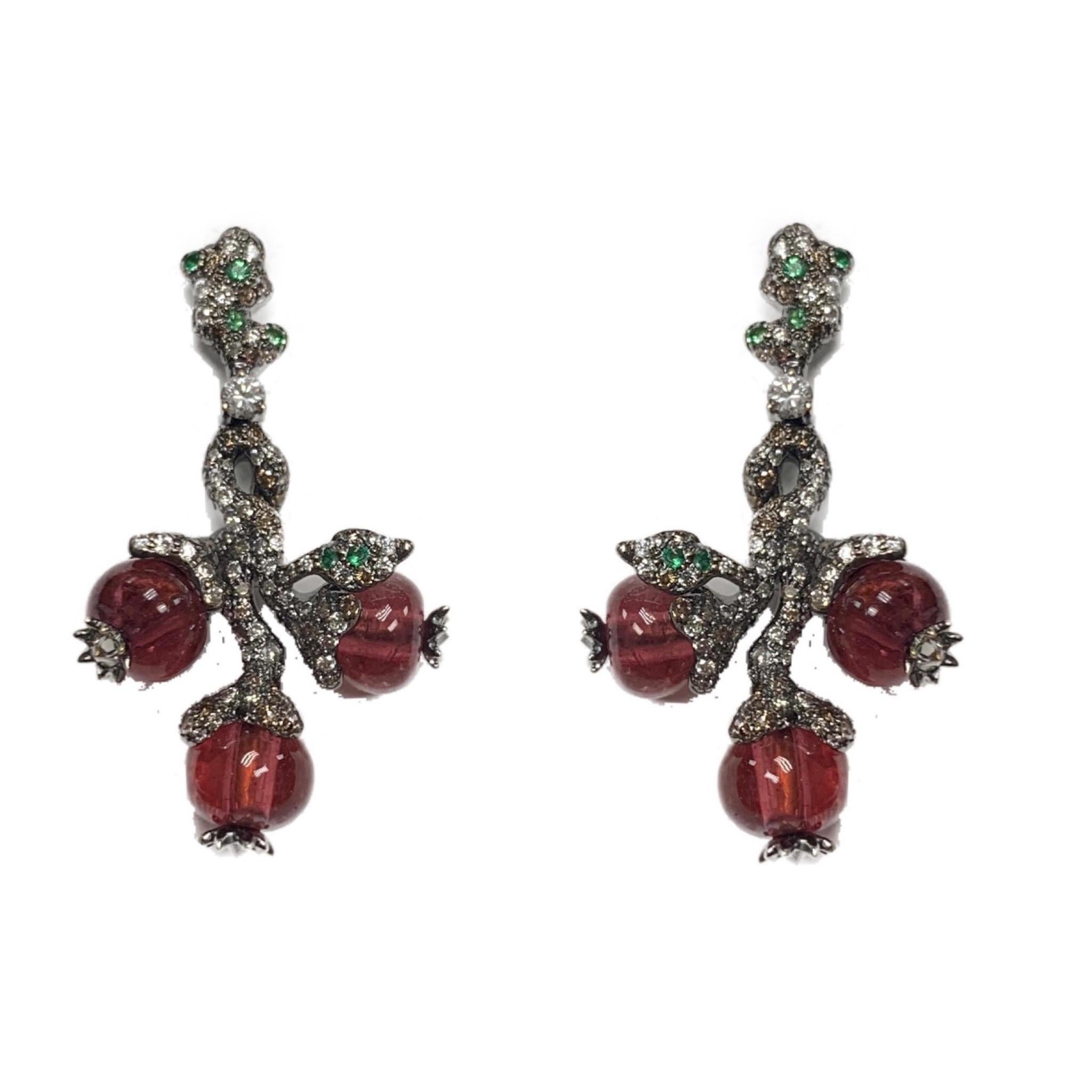 These eye-catching earrings feature 16.50 carats of bead-shaped rubellites, complemented by 0.19 carats of tsavorites and 2.16 carats of diamonds set in 18 karat blackened gold. Rubellite beads hang from the bottom and sides of these beautiful