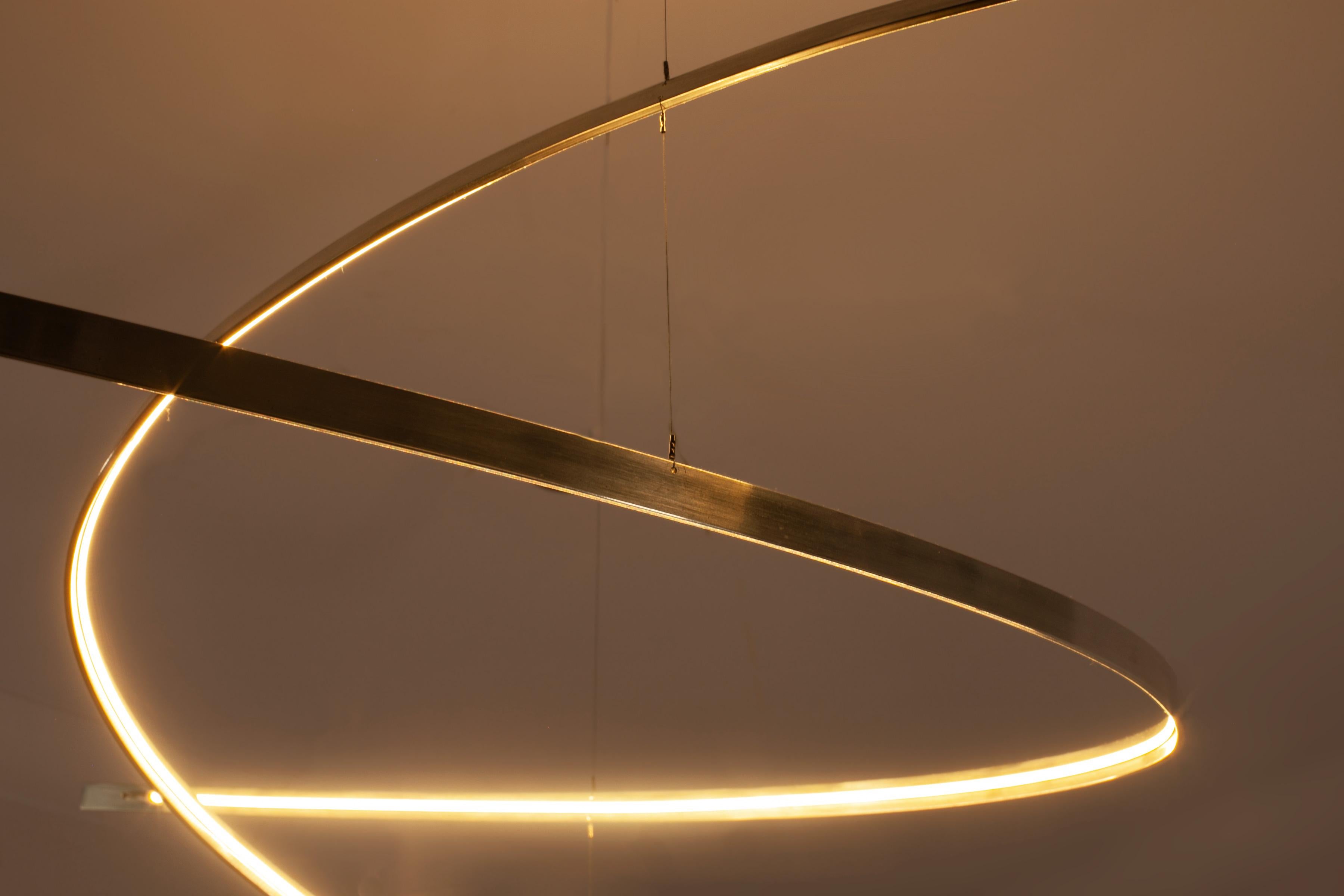 British Arx - a minimal, sculptural chandelier that emits rich, calm candle-like light For Sale