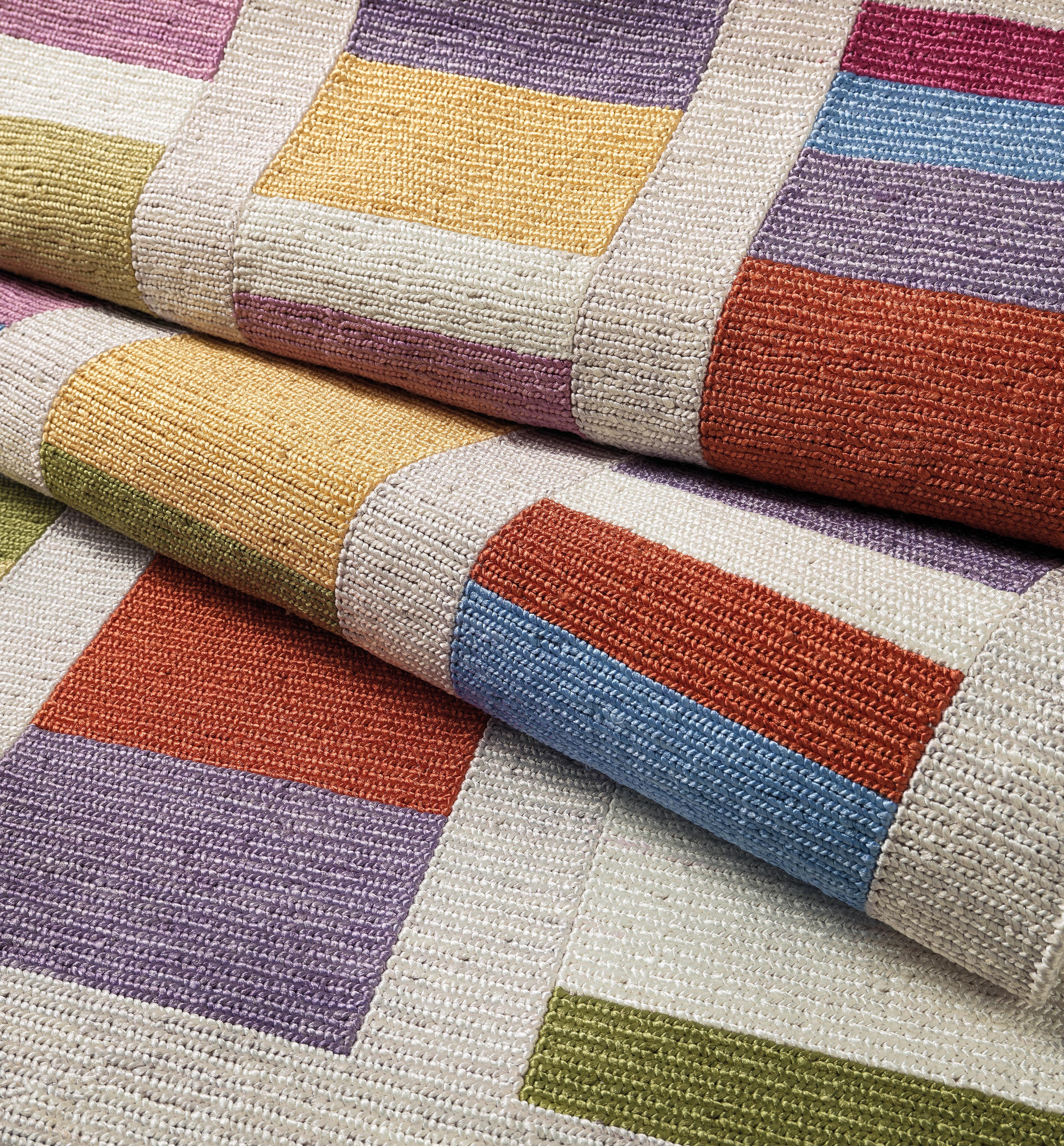 Missoni Home's outdoor, multi-colored, geometric rug with neutral ground; made to withstand outdoor elements
 
