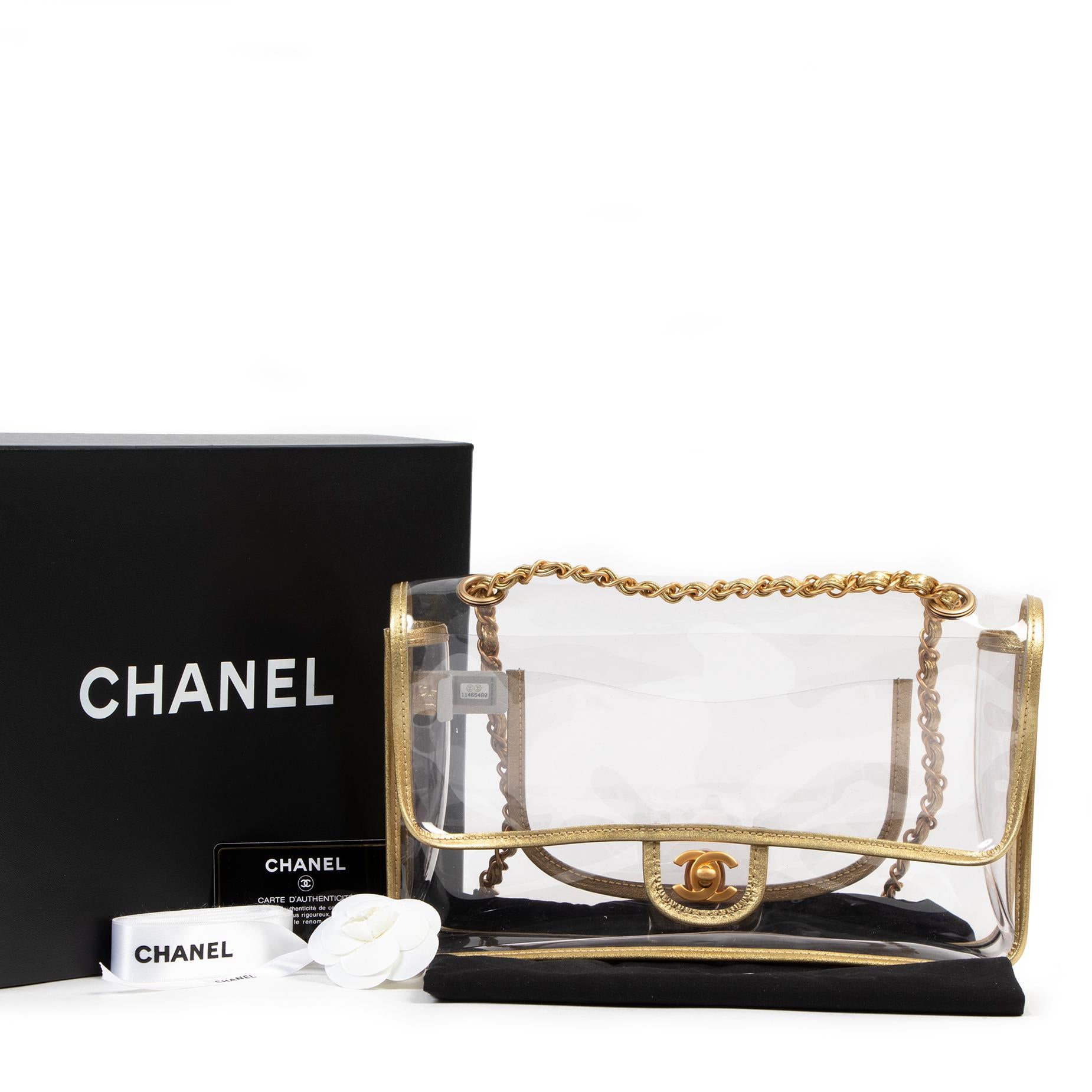 As New

As New Chanel Limited PVC Classic Flap Bag

WOW make heads turn with this limited Chanel Transparent Classic Medium Flap Bag finished with metallic gold lambskin piping.
The front matt gold cc lock opens with a front flap to a spacious
