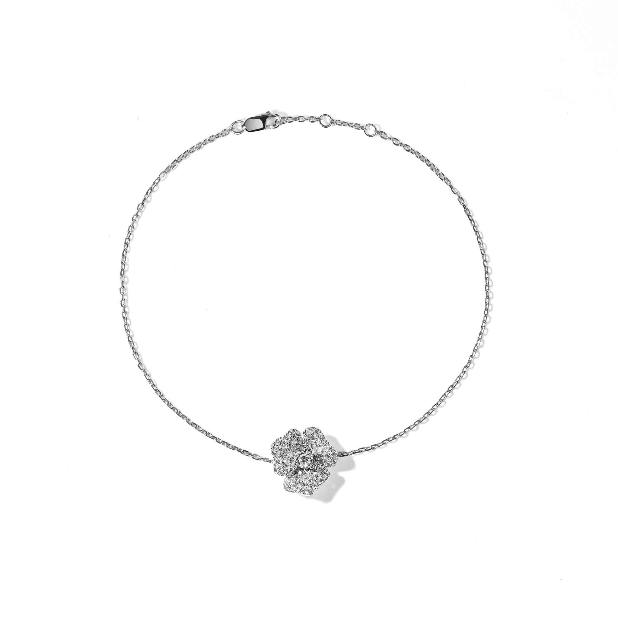 Crafted in 18K white gold, this elegant bracelet is encrusted with White Diamonds and has a White Sapphire Stone at its center. 

Part of our bloom collection, this pansy flower-inspired piece was designed to remind you of the infinite possibilities