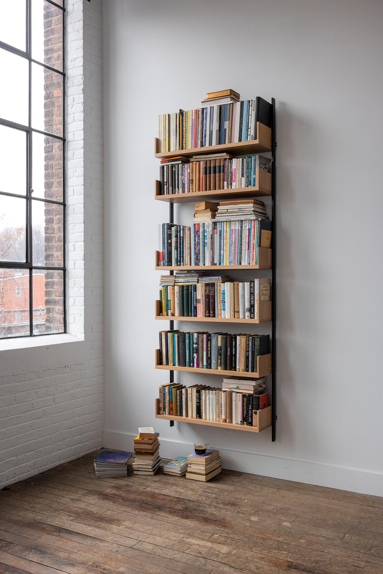 The AS4 modular shelving unit is handmade using solid hardwood with dovetail joinery, and solid steel.  This single-bay shelving unit can easily be rearranged, expanded upon, and relocated - adapting to your needs as they change (unlike traditional