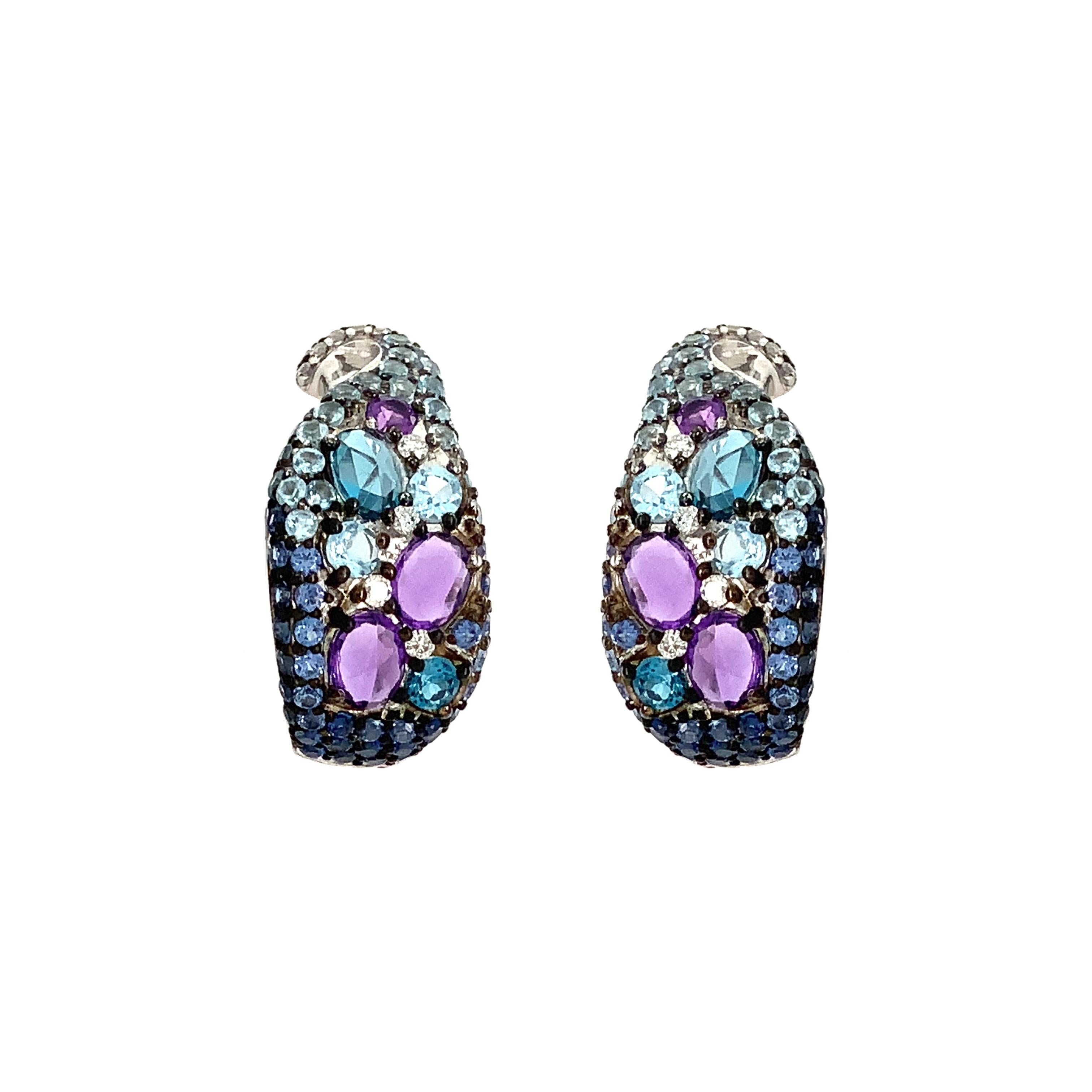 These elegant ASBA Collection Earrings have a striking Ombre pattern of Sapphires, Amethysts, Blue Topaz, and Diamonds, all set in 14K White Gold. The Sapphires total 0.70 ctw, Amethysts 0.60 ctw, and Blue Topaz 0.30 ctw, while the Diamonds come to