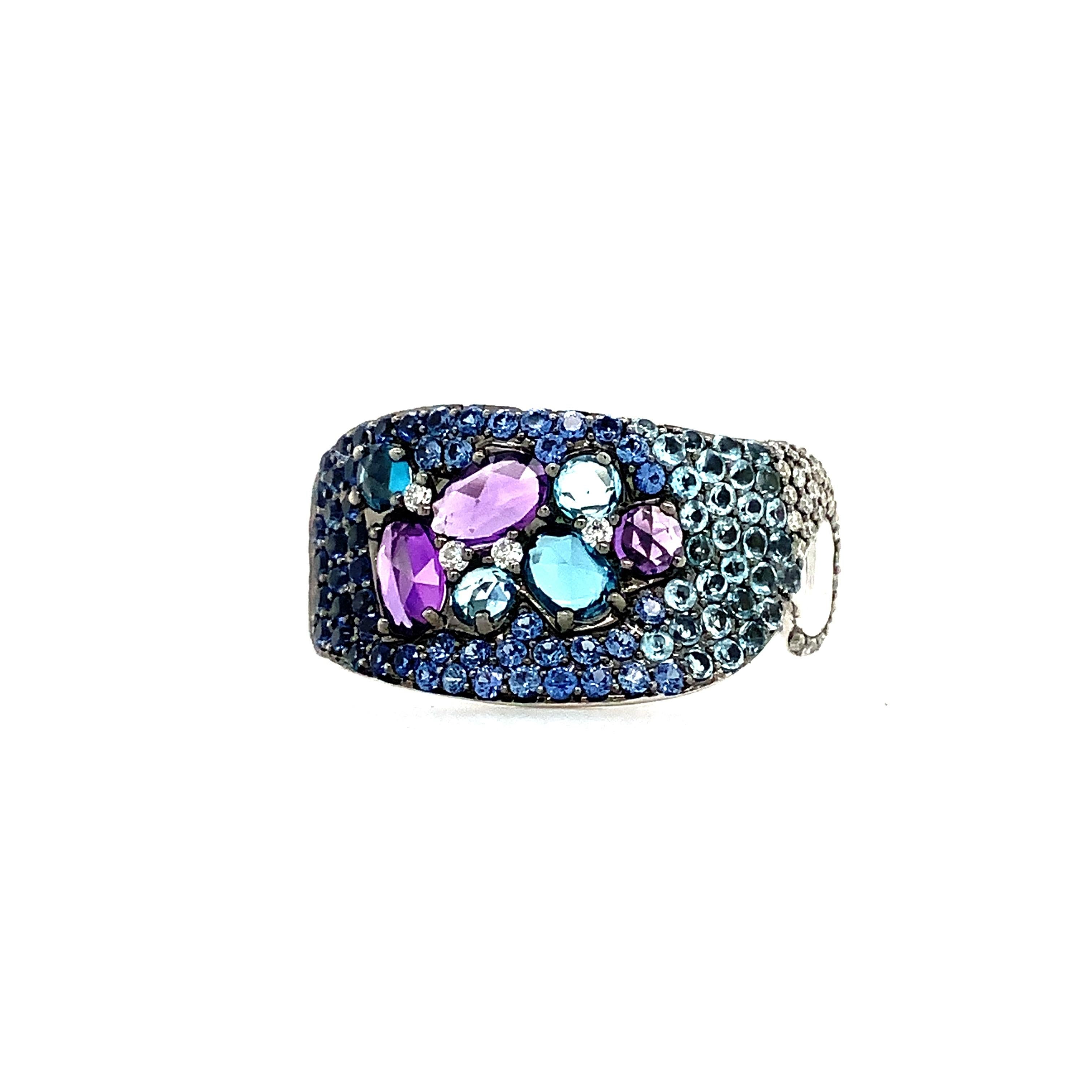 This ASBA Collection Ombre Pave Ring features Blue Sapphire, Diamond, Blue Topaz, and Amethyst stones set in 14K White Gold. With a width of 11.44mm and a depth of 2.16mm, the total carat weight of the ring is 2.31ctw, including 0.86ctw of