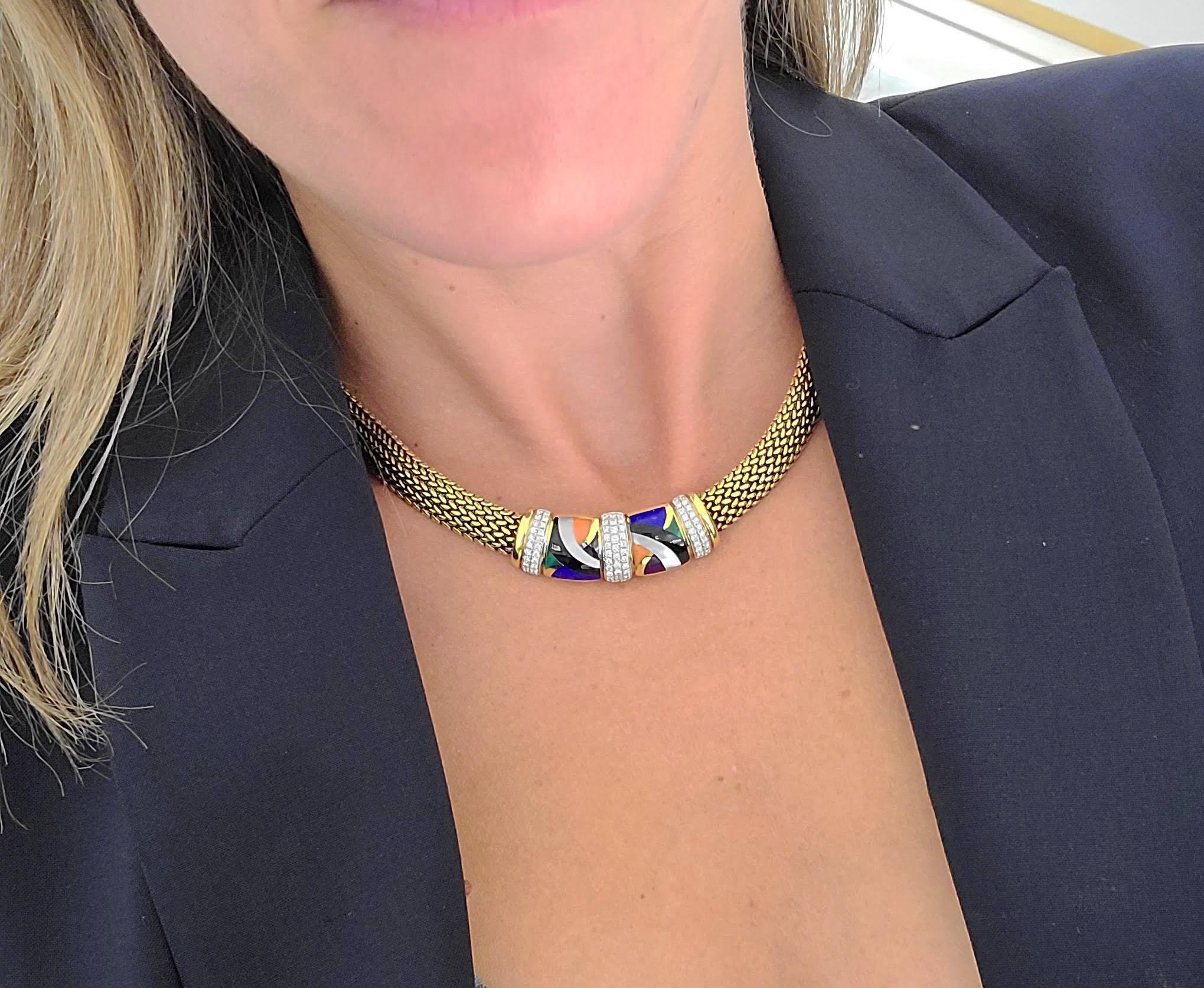 Available at Cellini Jewelers NYC, This beautiful Asch Grosbardt 18 karat yellow gold necklace is designed with a yellow gold bombe mesh chain. The centerpiece is inlaid in a geometric motif of Black Onyx, Mother of Pearl, Coral, Lapis Lazuli, &