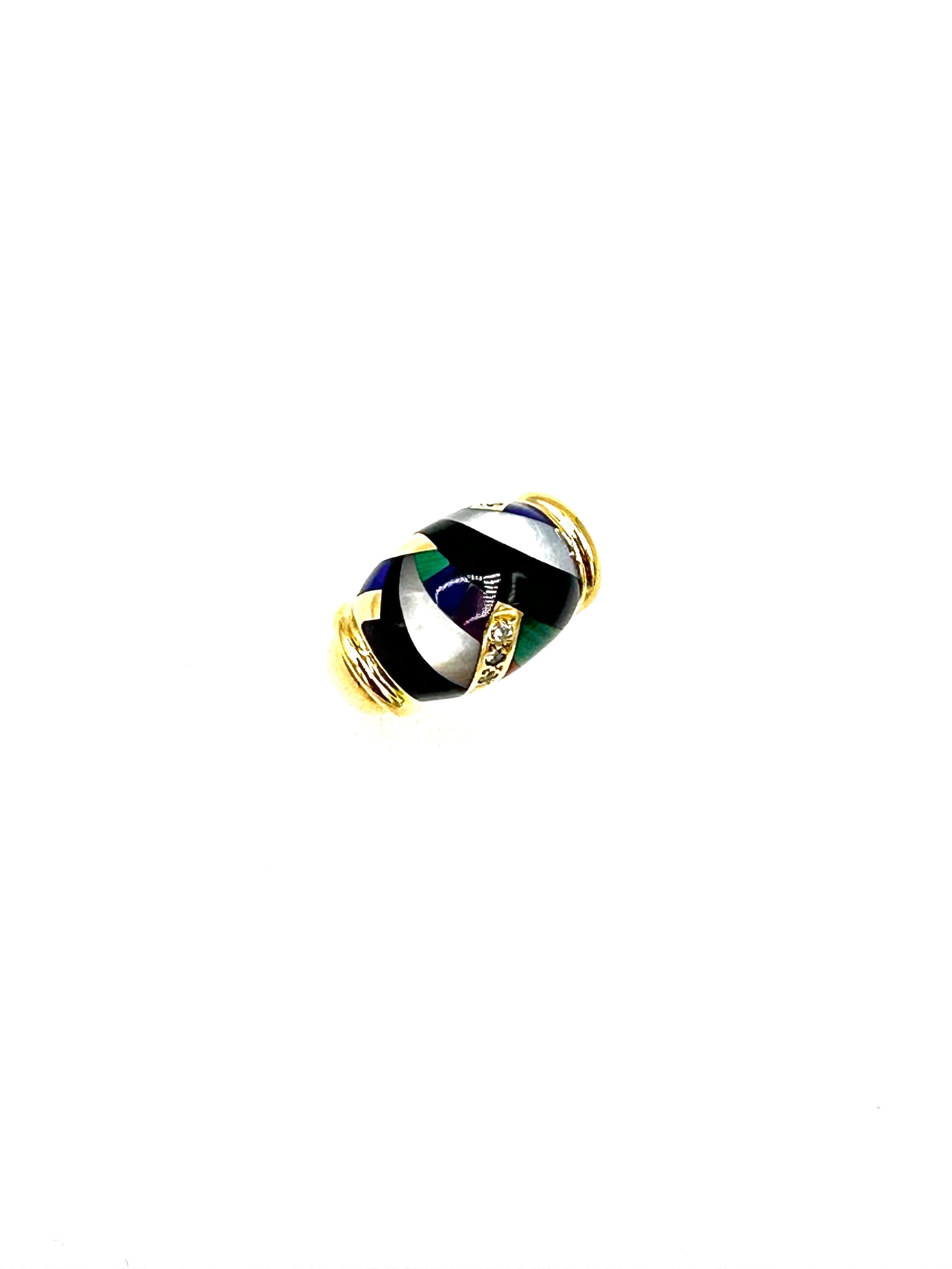 The slightly domed ring is embellished by an arabesque of inlaid gemstones including coral, lapis lazuli, malachite, mother of pearl, and onyx, intercepted by solid gold and Diamond-set motifs. This is a versatile ring that functions well when you