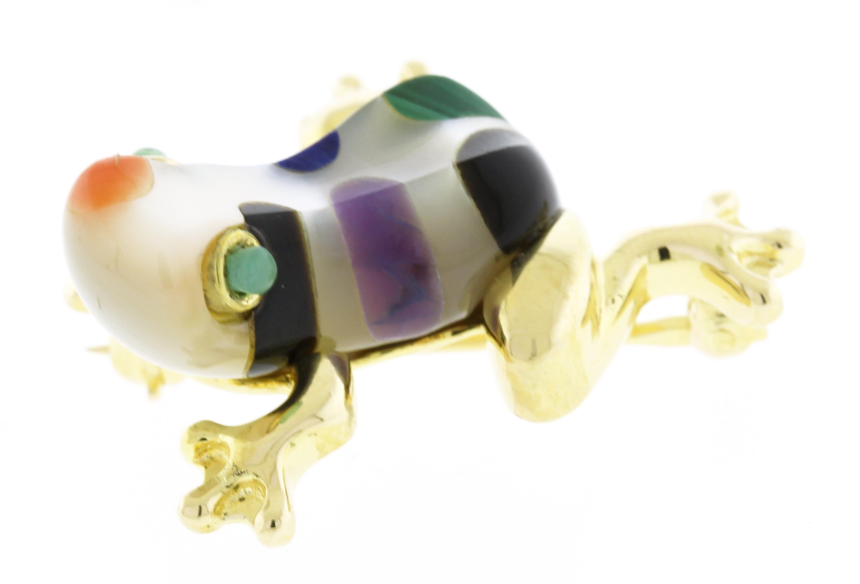 From Asch Grossbardt, this brooch is inlaid with different gemstones.
♦ Designer: Asch Grossbardt
♦ Metal: 14kt yellow gold
♦ Gemstone: Mother of pearl body with multi-gemstones
♦ Circa: 1980
♦ Length: 1 inch
♦ Width: 3/4 inches
♦ Packaging:
