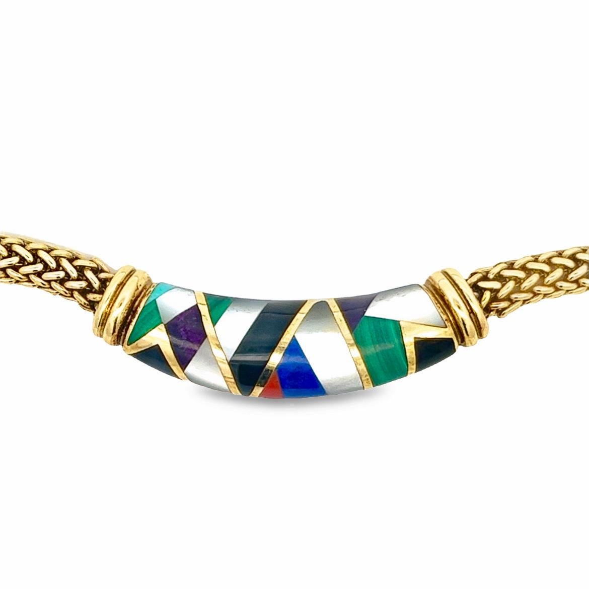 This Asch Grossbardt piece displays vibrant, playful, and classical characteristics. Made up of 18 karat yellow gold mesh chain and a centerpiece inlayed with geometric mother of pearl, black onyx, coral, malachite, lapis, and turquoise. The clasp