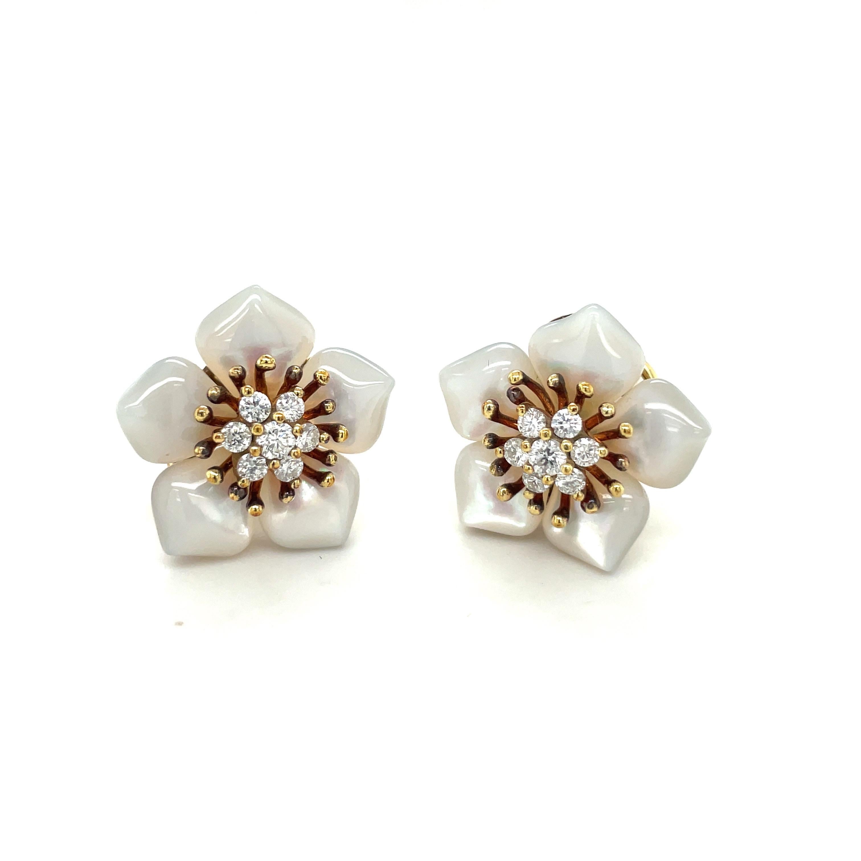 18 karat yellow gold flower earrings by Asch Grossbardt. The petals are set with beautifully shaped mother of pearl. The center of the flowers are set with a total of 14 round brilliant diamonds totaling 0.80carats. The 7/8